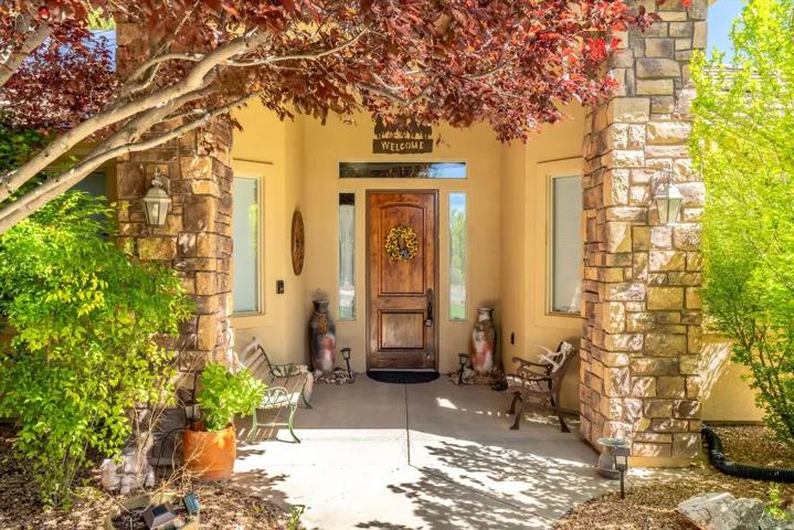 Doorway to property with stucco siding and stone siding