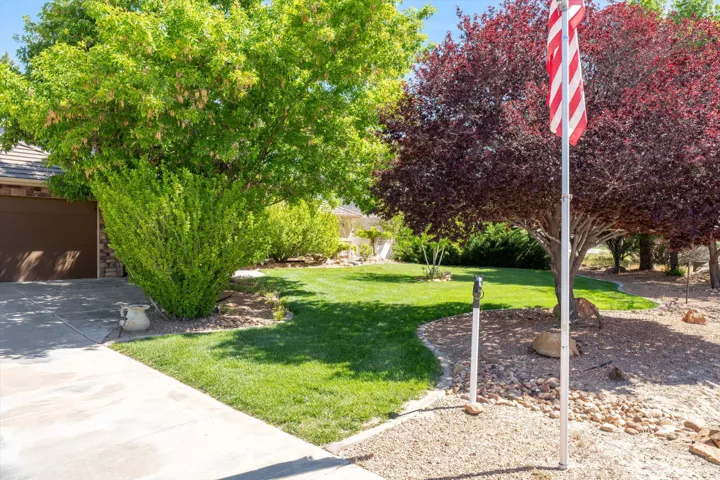 View of grassy yard with a garage