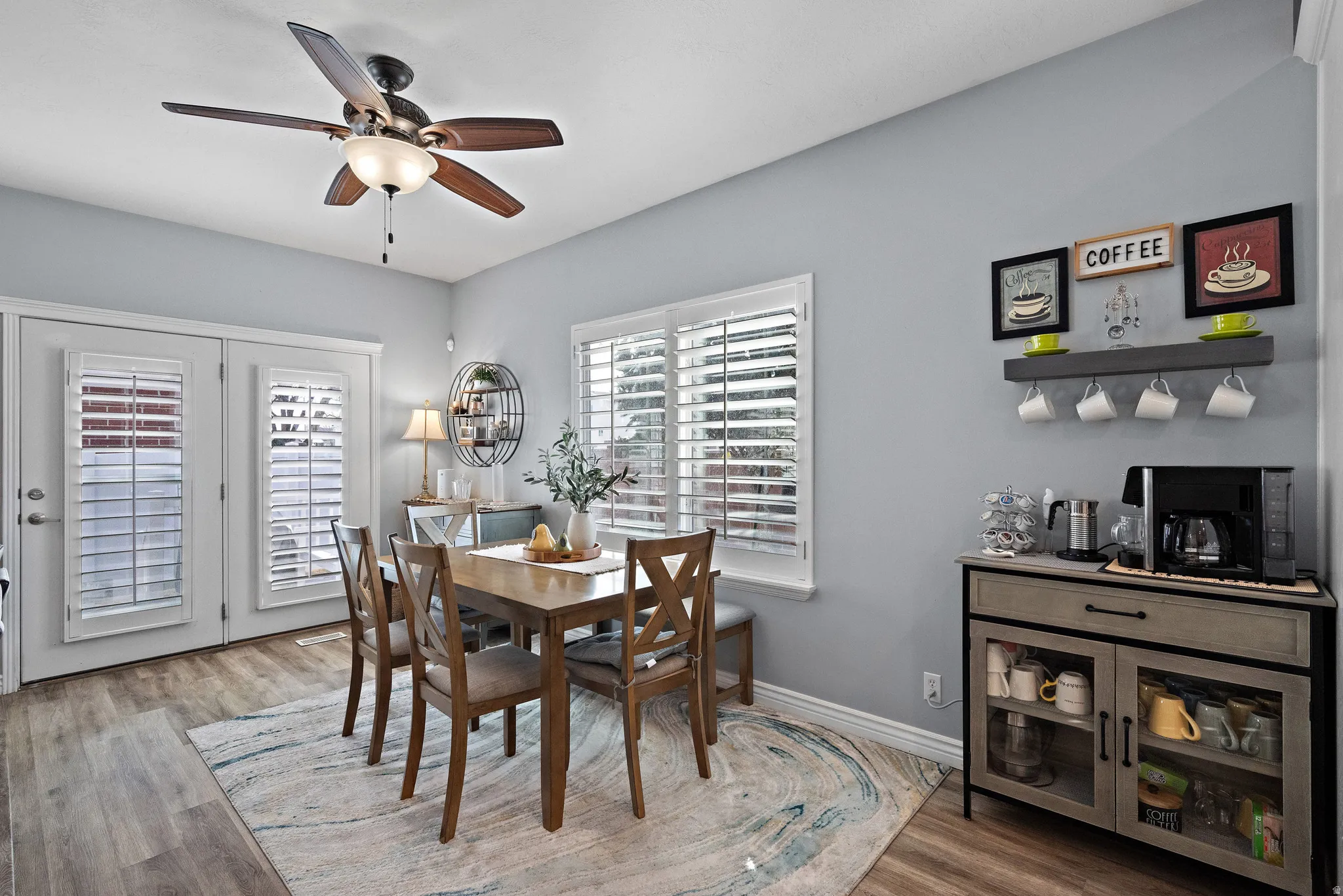 Dining space featuring wood finished floors and a ceiling fan