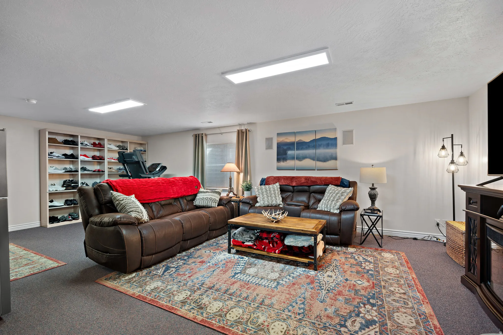 Carpeted living room featuring a textured ceiling