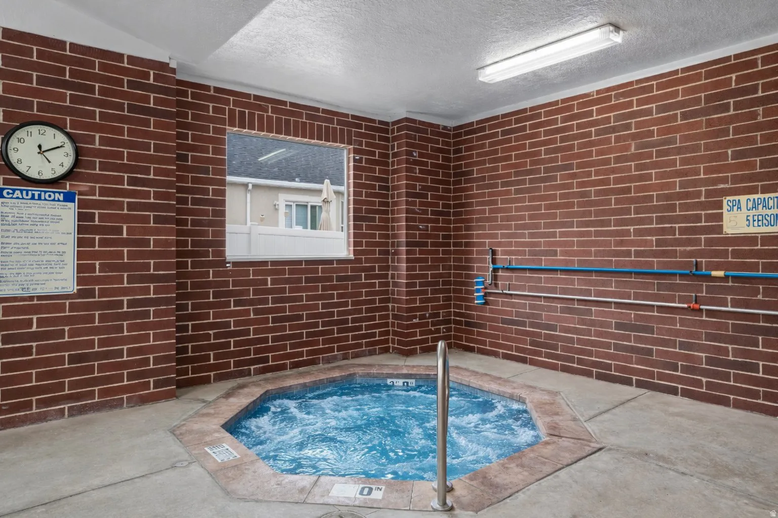 View of pool featuring a hot tub