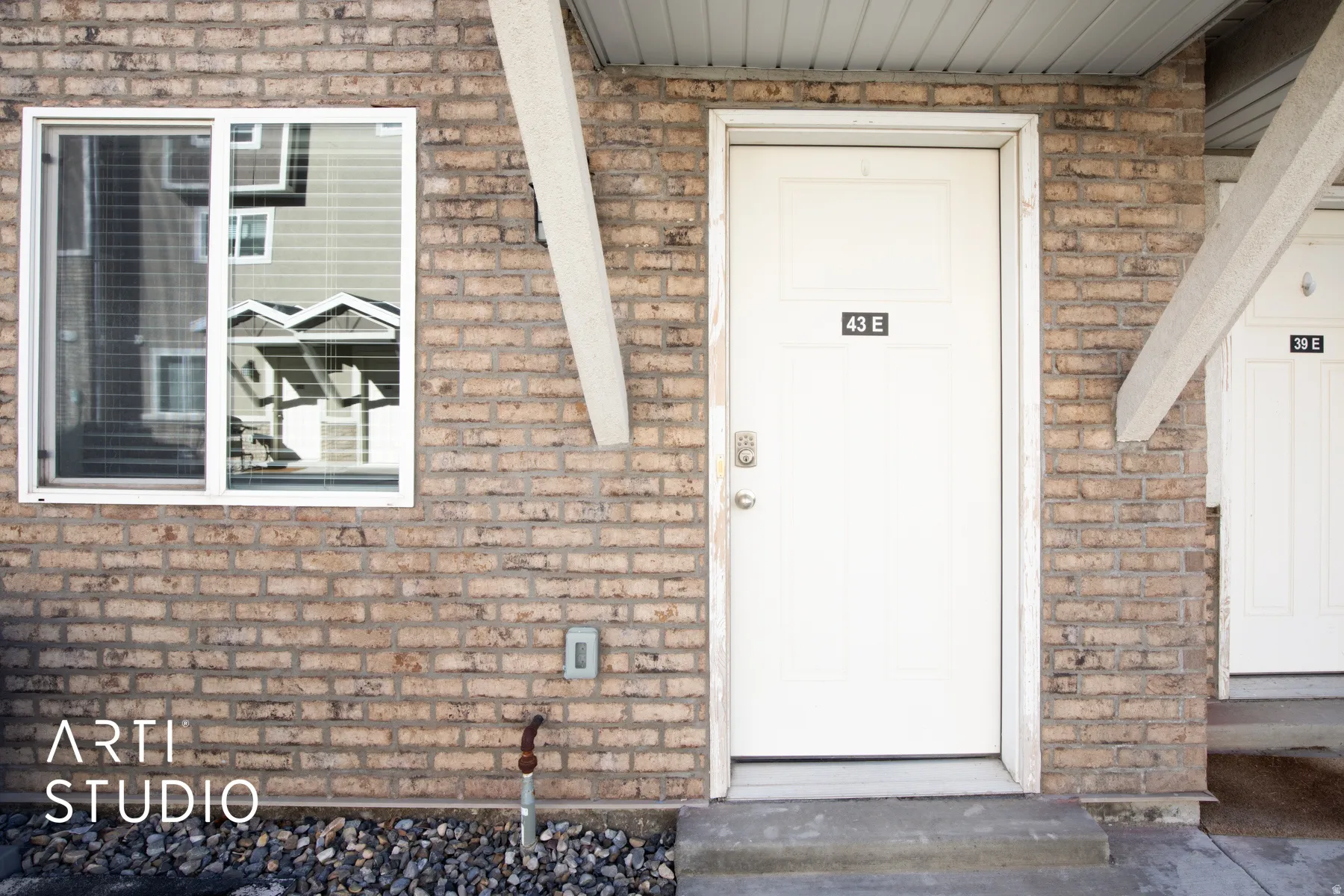 Entrance to property featuring brick siding
