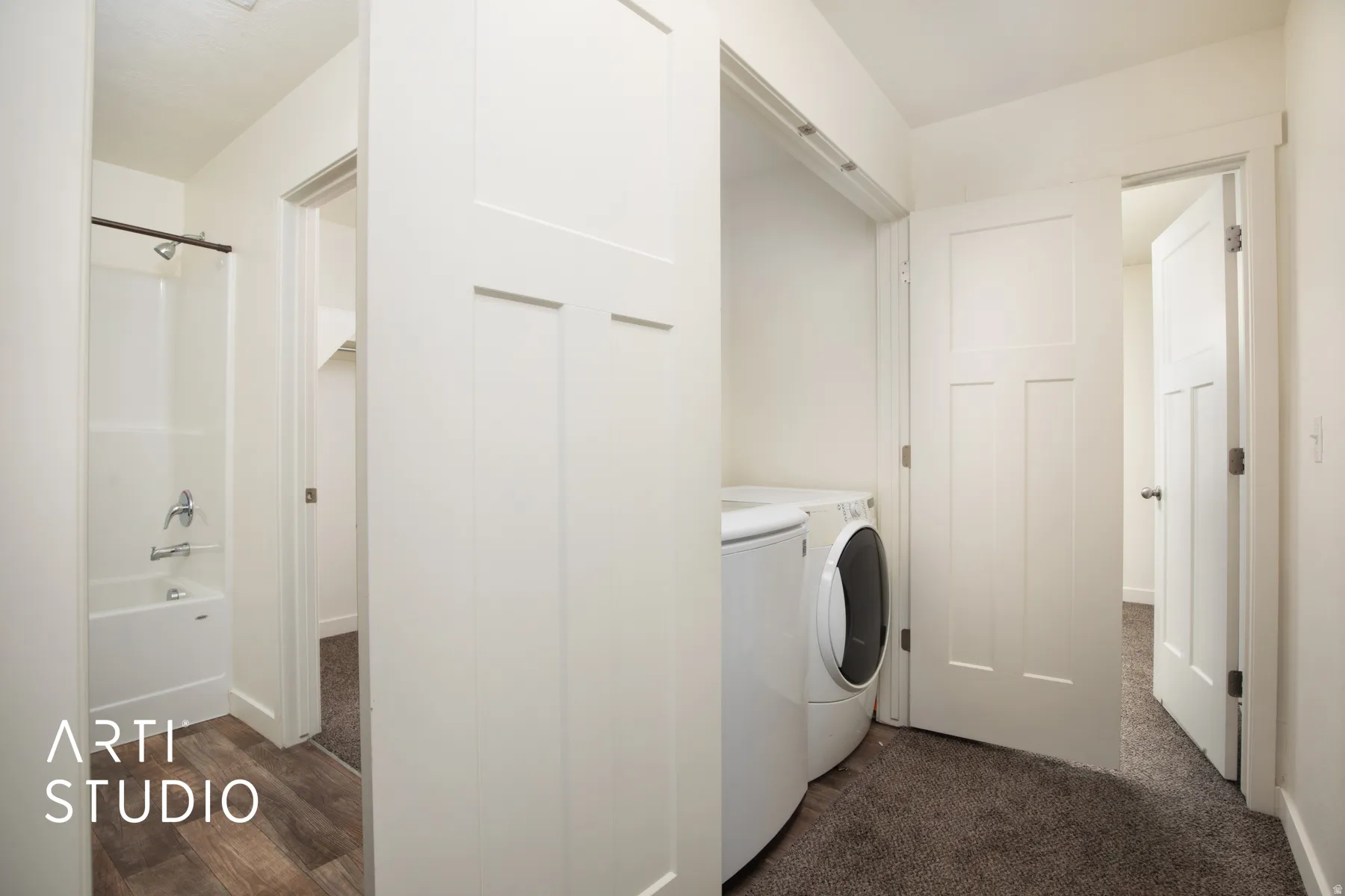 Laundry area with washer and dryer and dark wood-style flooring