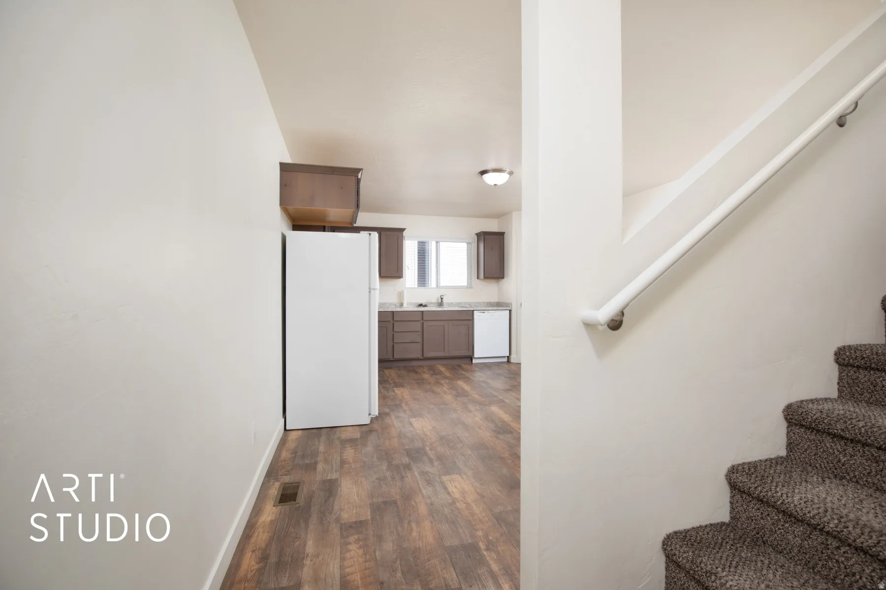 Stairway featuring wood finished floors and baseboards