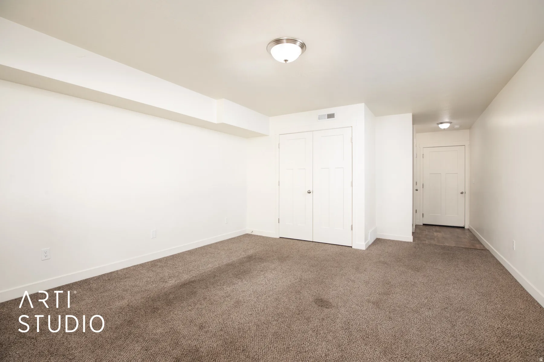 Unfurnished bedroom with carpet flooring and a closet
