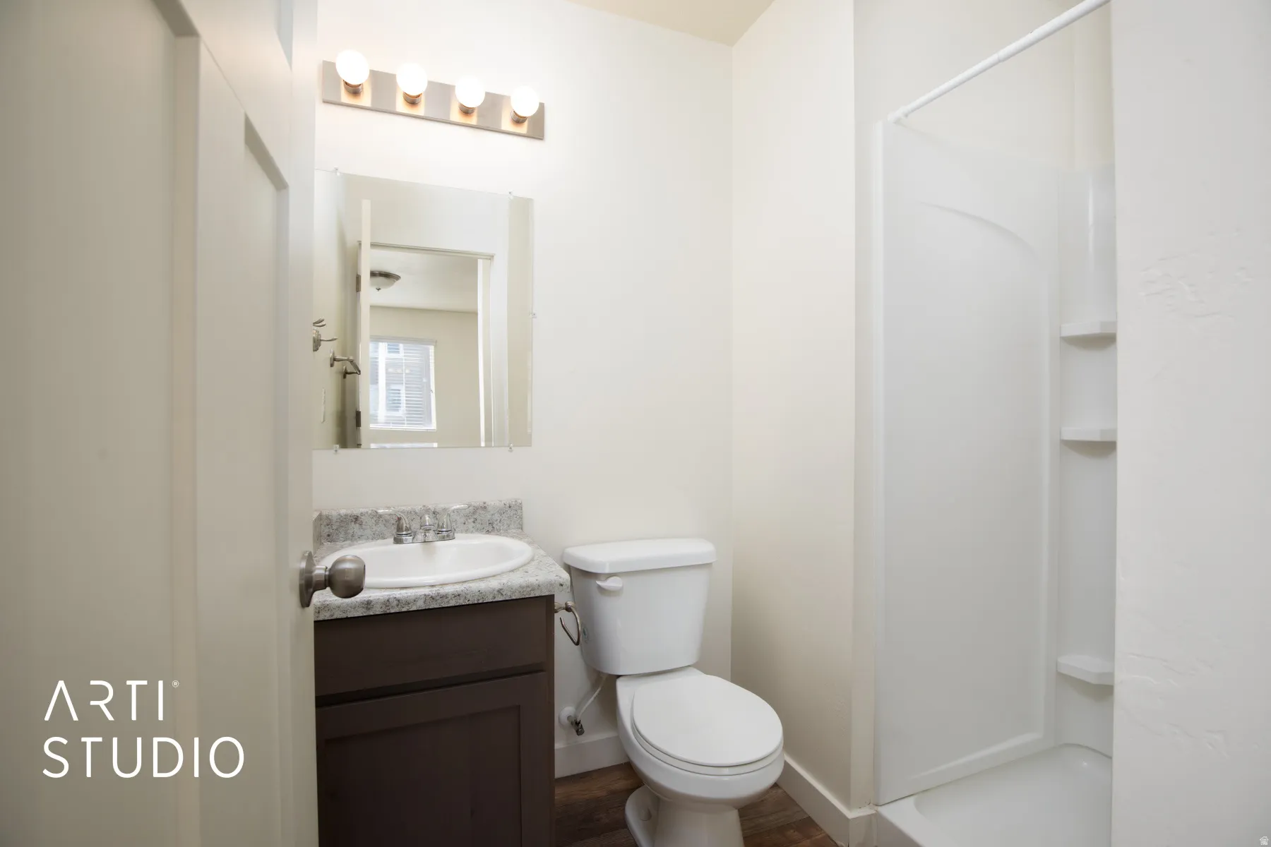 Full bathroom featuring vanity, a shower stall, and dark wood-style floors