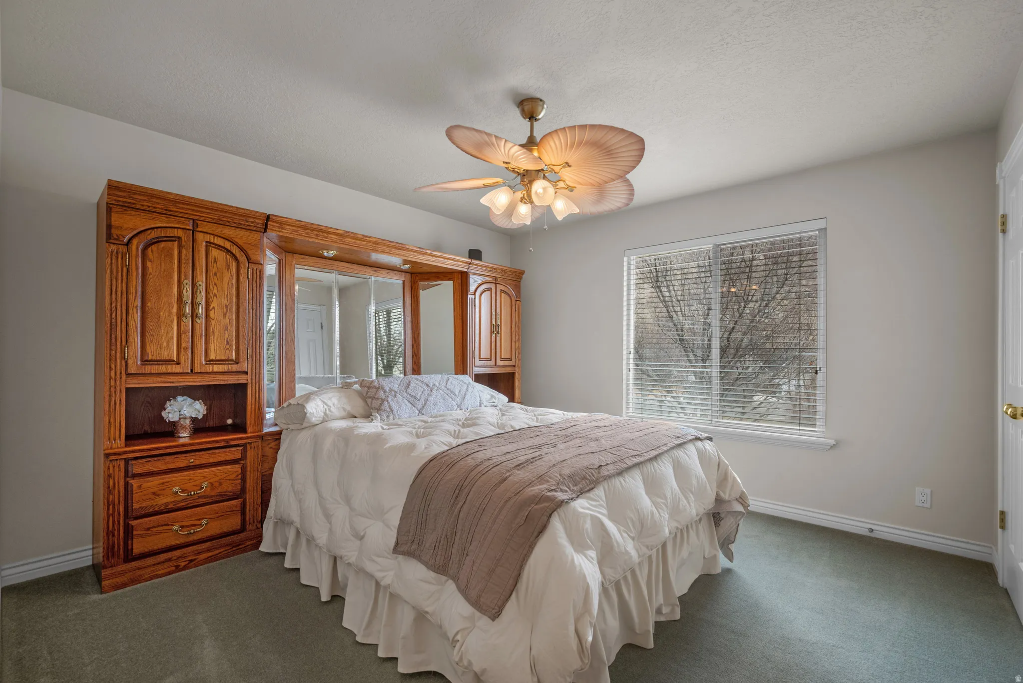 Guest Bedroom with ceiling fan and medium carpet
