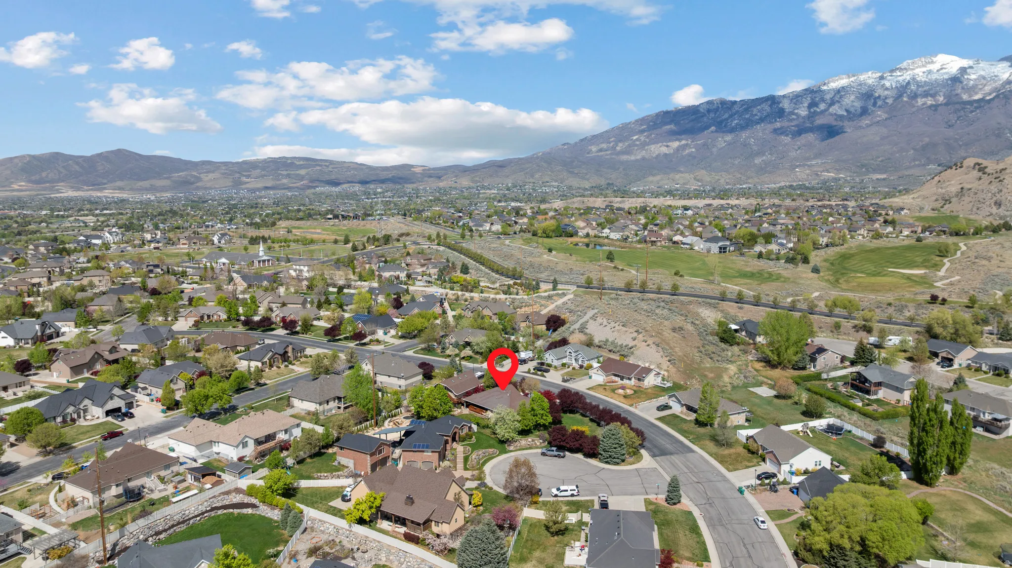 Aerial perspective of suburban area with a mountain backdrop