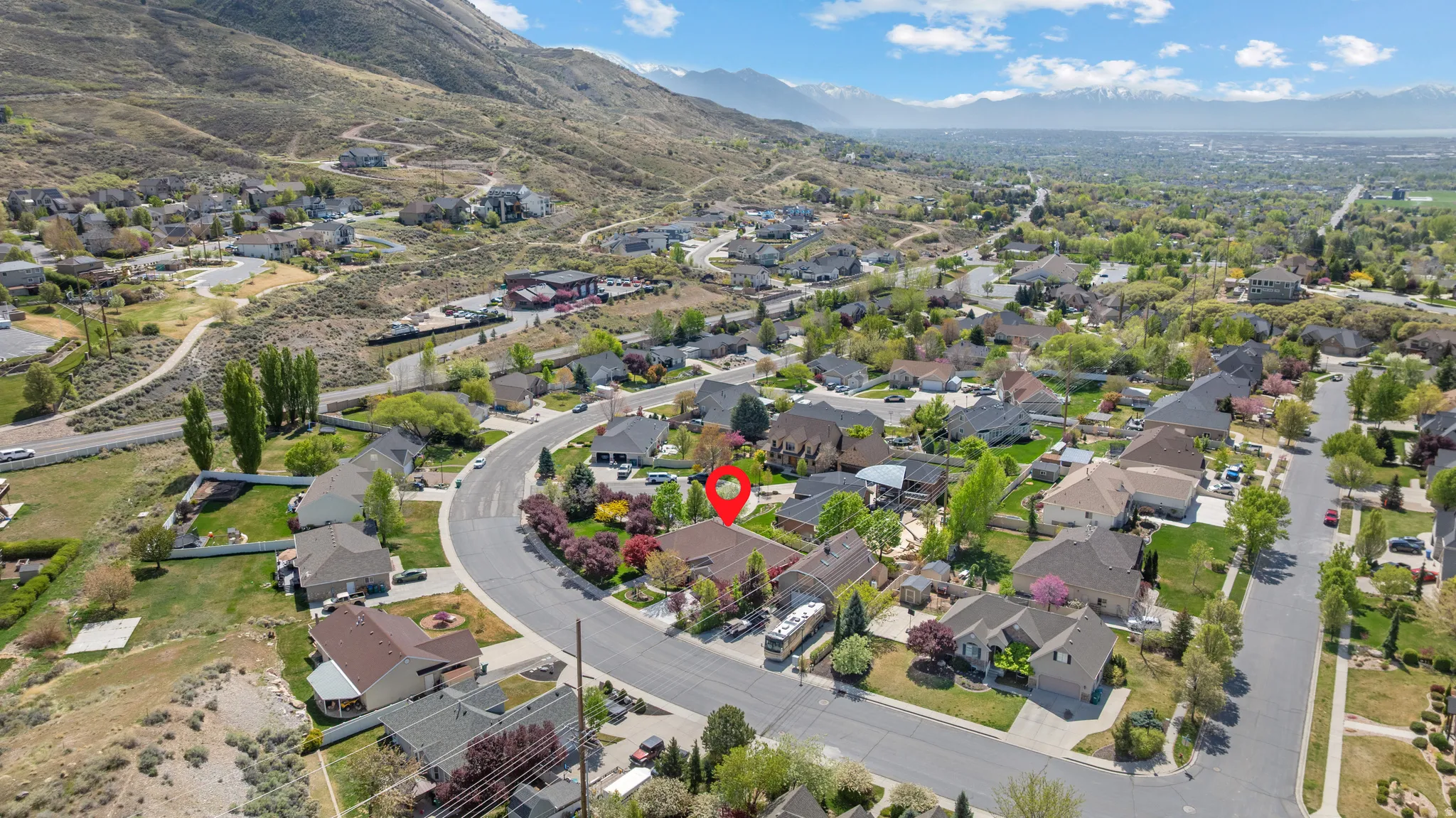 Aerial view of residential area featuring a mountainous background