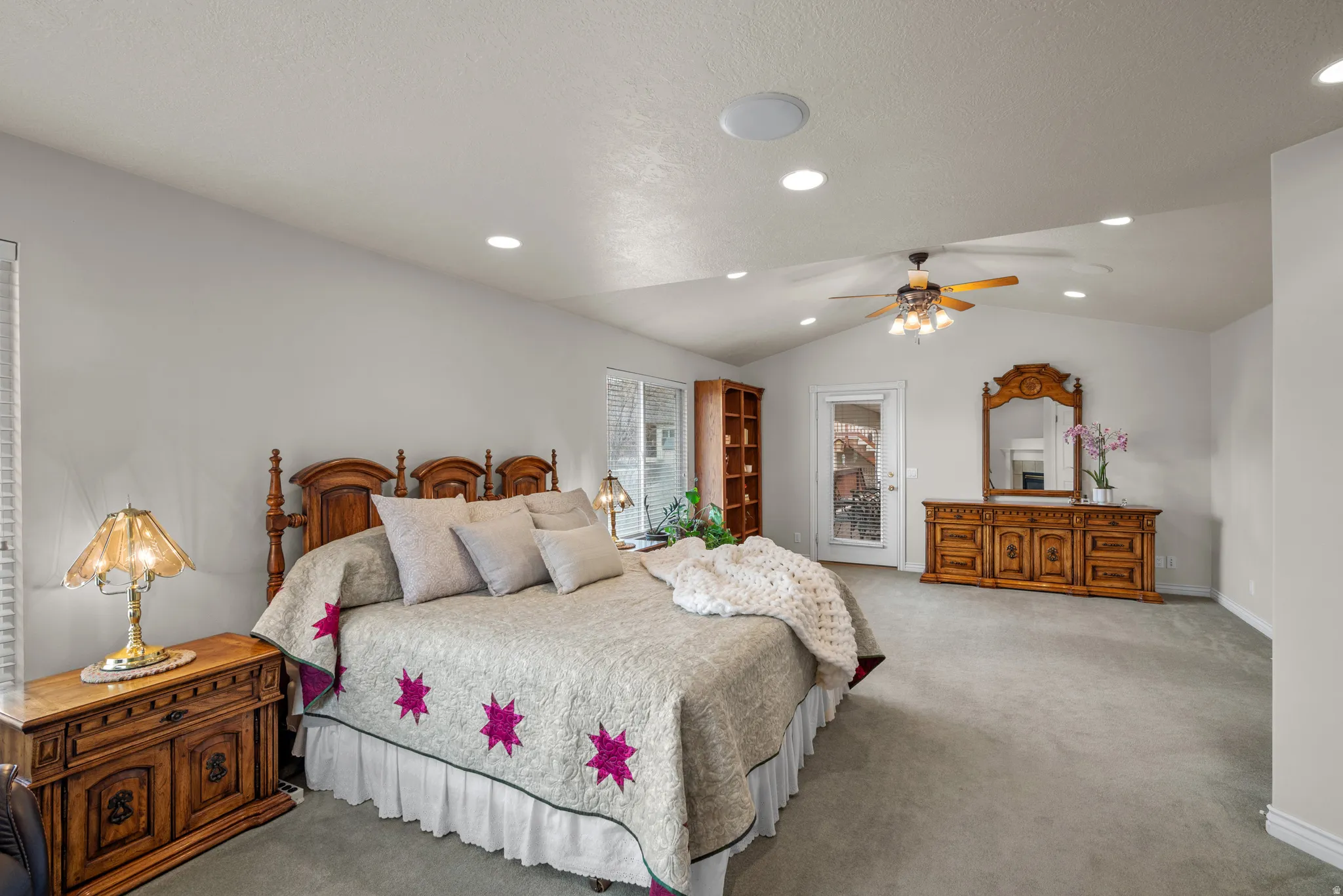Carpeted Primary Suite with a ceiling fan