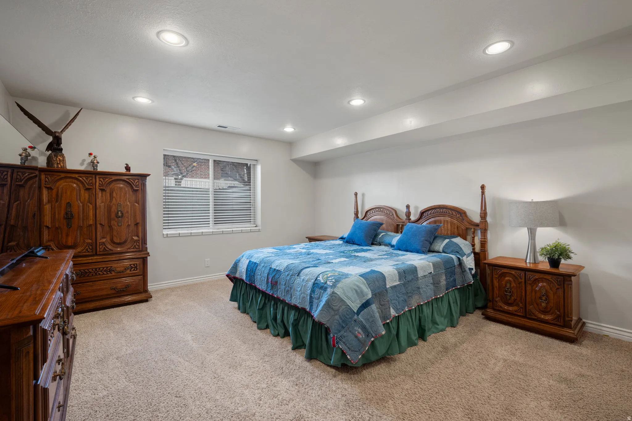 Bedroom with light carpet and recessed lighting