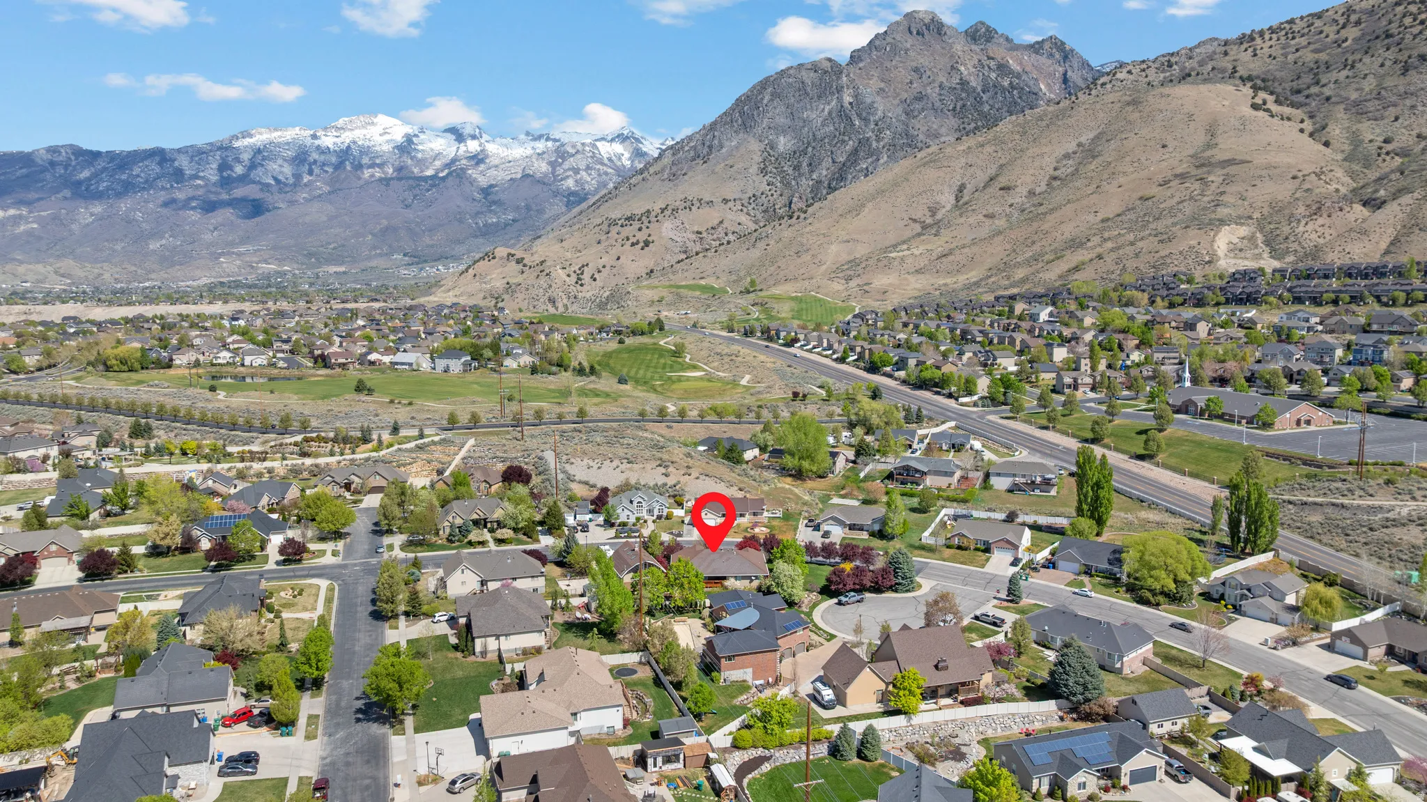 Aerial perspective of suburban area with a mountain backdrop