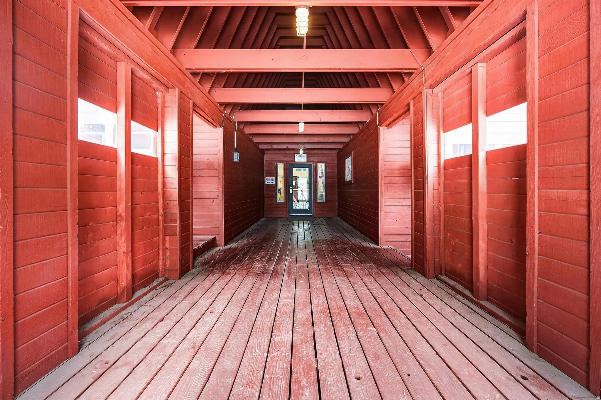Hallway featuring beamed ceiling and hardwood / wood-style floors