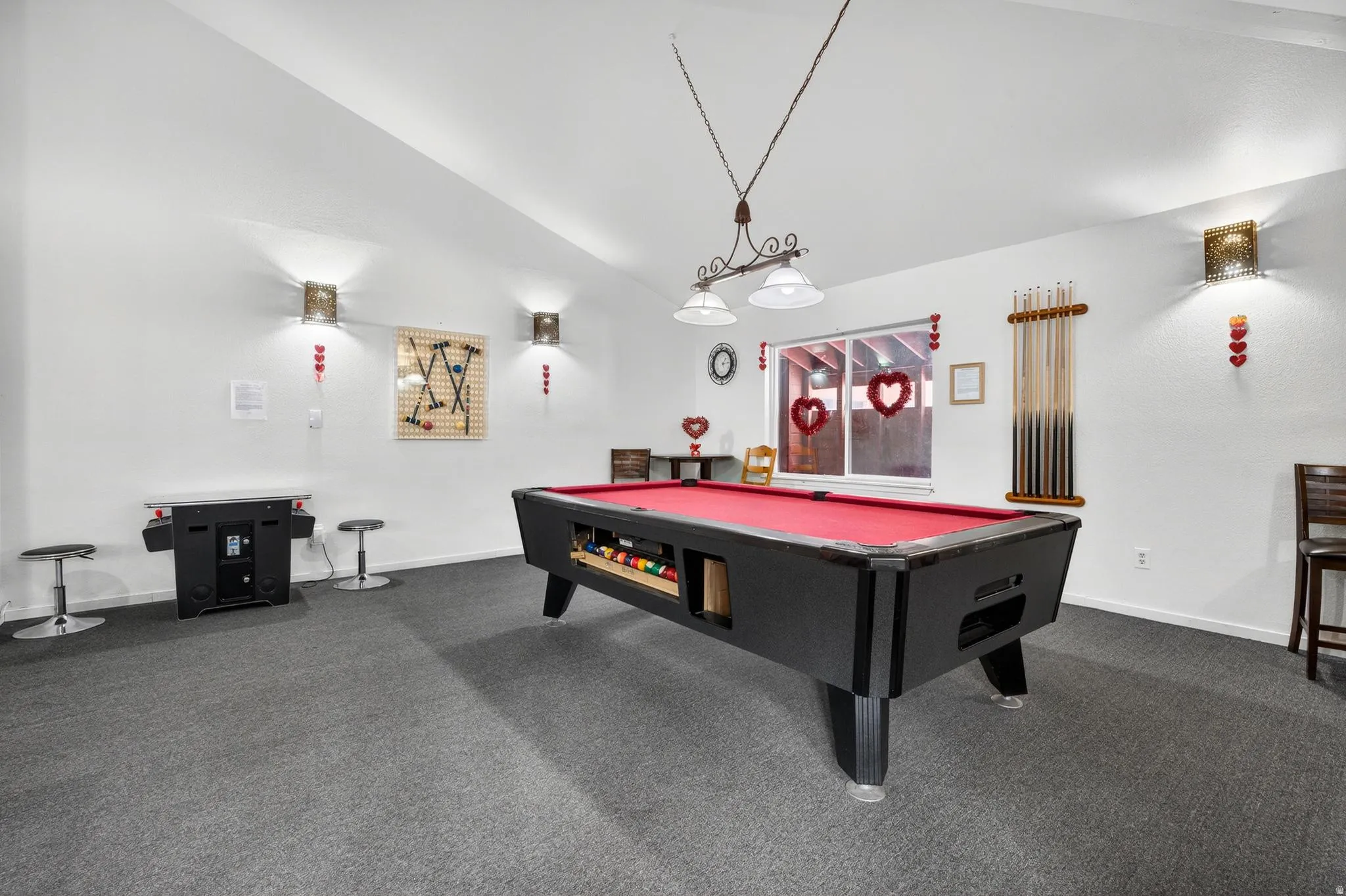 Recreation room featuring dark colored carpet, pool table, and lofted ceiling
