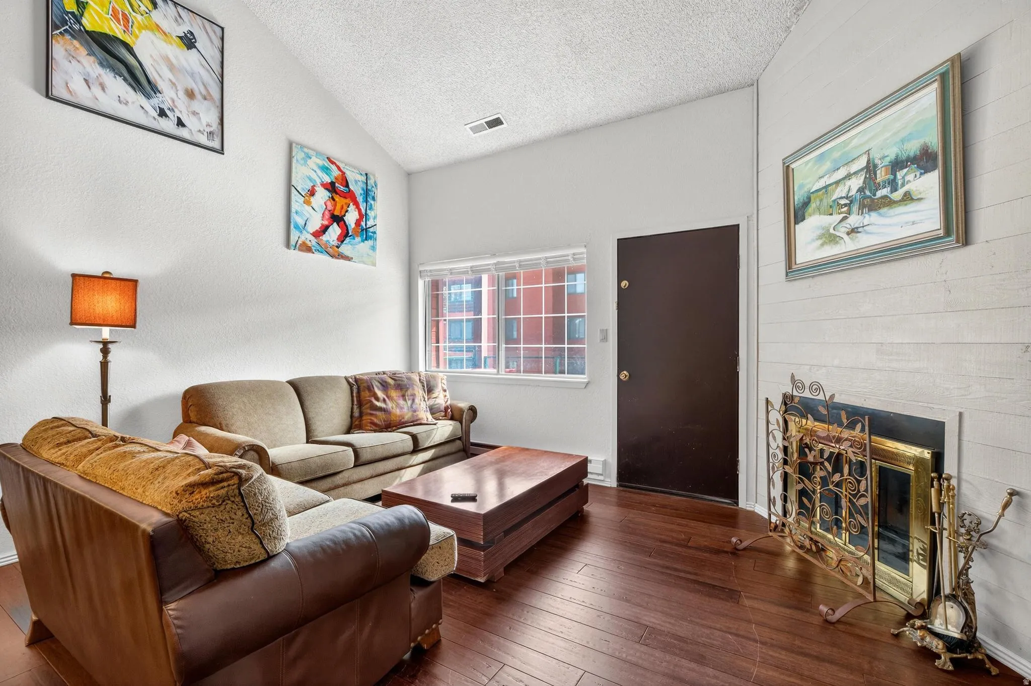 Living area featuring hardwood / wood-style flooring and a glass covered fireplace