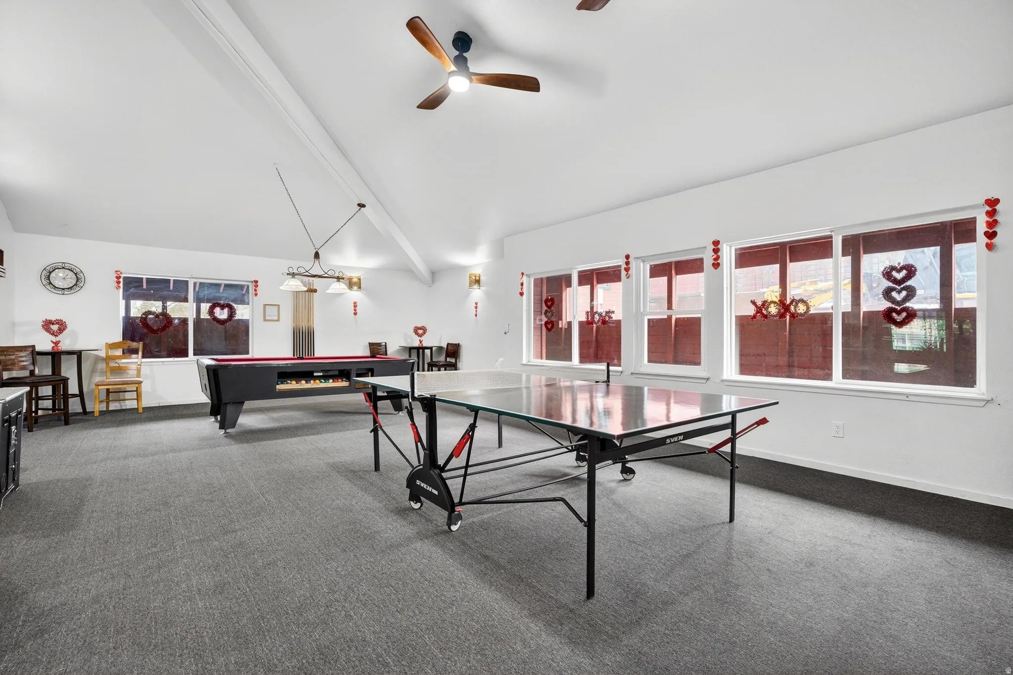 Recreation room with billiards table, lofted ceiling with beams, and a ceiling fan