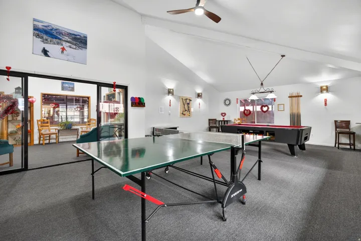 Recreation room featuring ceiling fan, lofted ceiling, and pool table