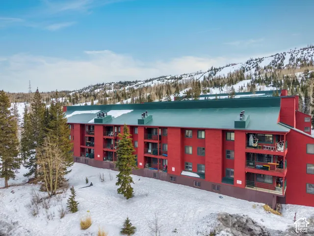 Snow covered building with a view of apartment building / complex