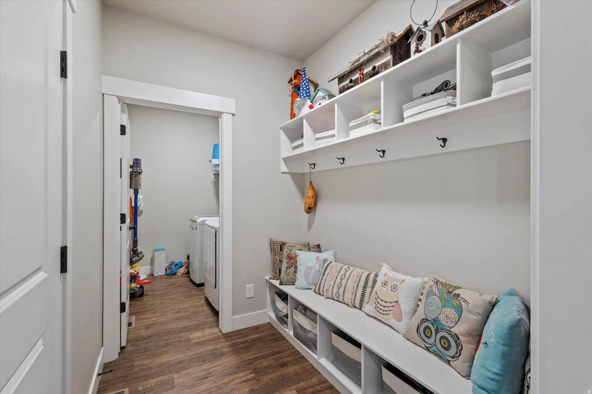 Mudroom with dark wood-type flooring and independent washer and dryer