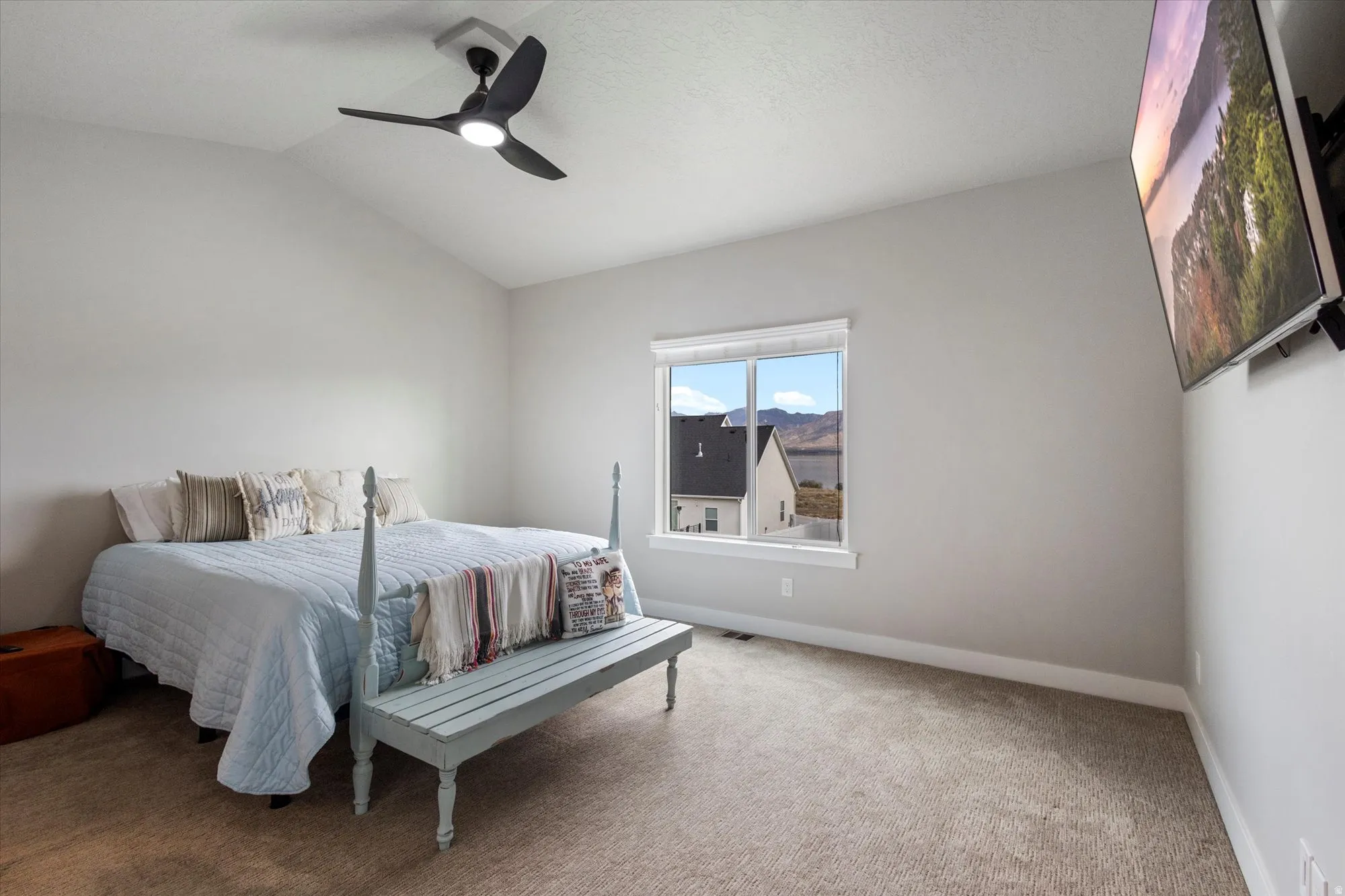 Bedroom featuring carpet flooring, lofted ceiling, and ceiling fan