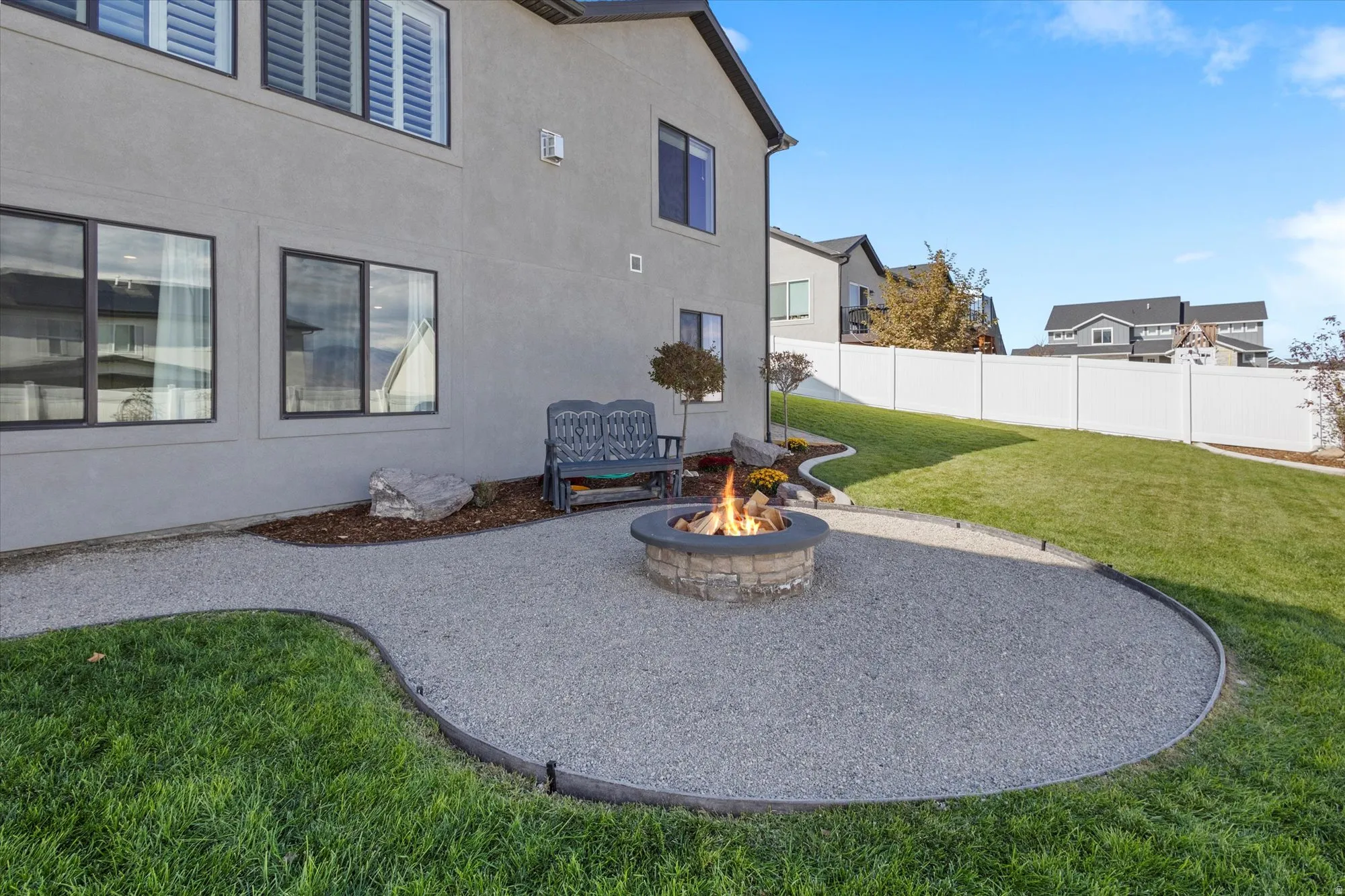 Fenced yard featuring a patio area and a fire pit