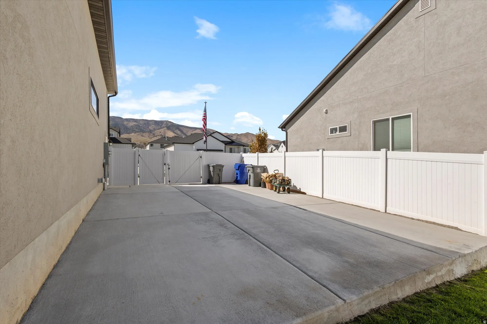 Fenced backyard with a gate and a residential view