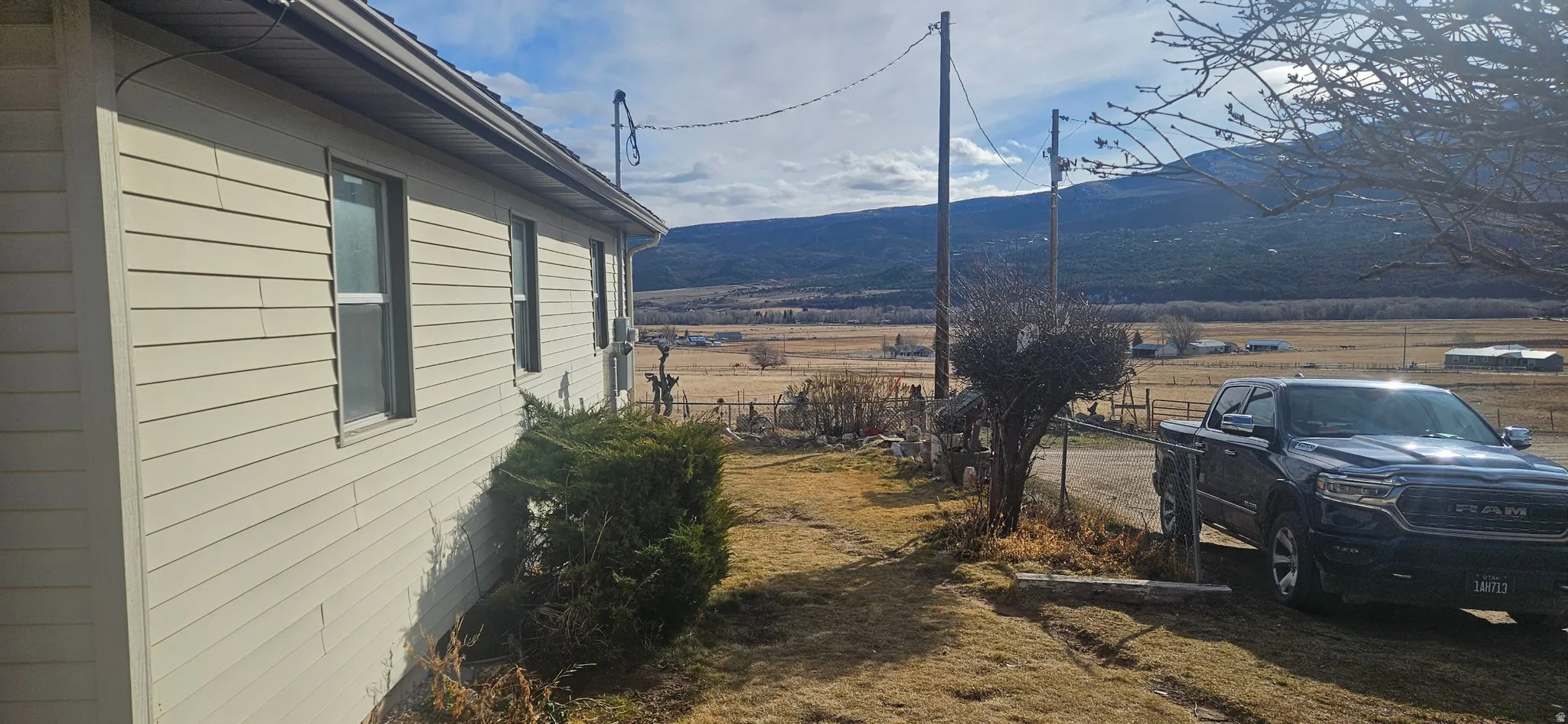 View of side of home featuring a rural view and a mountain view