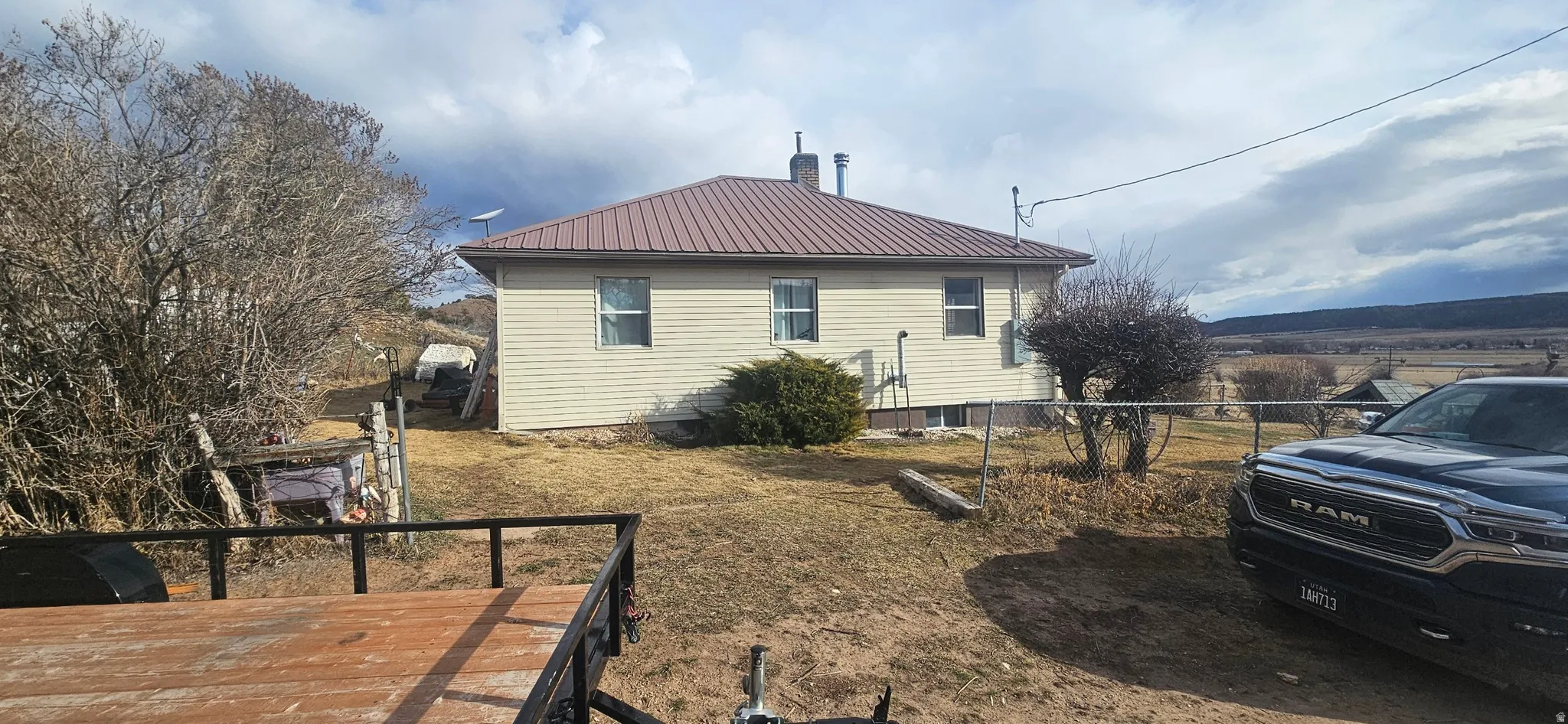 View of side of home with a metal roof and a chimney