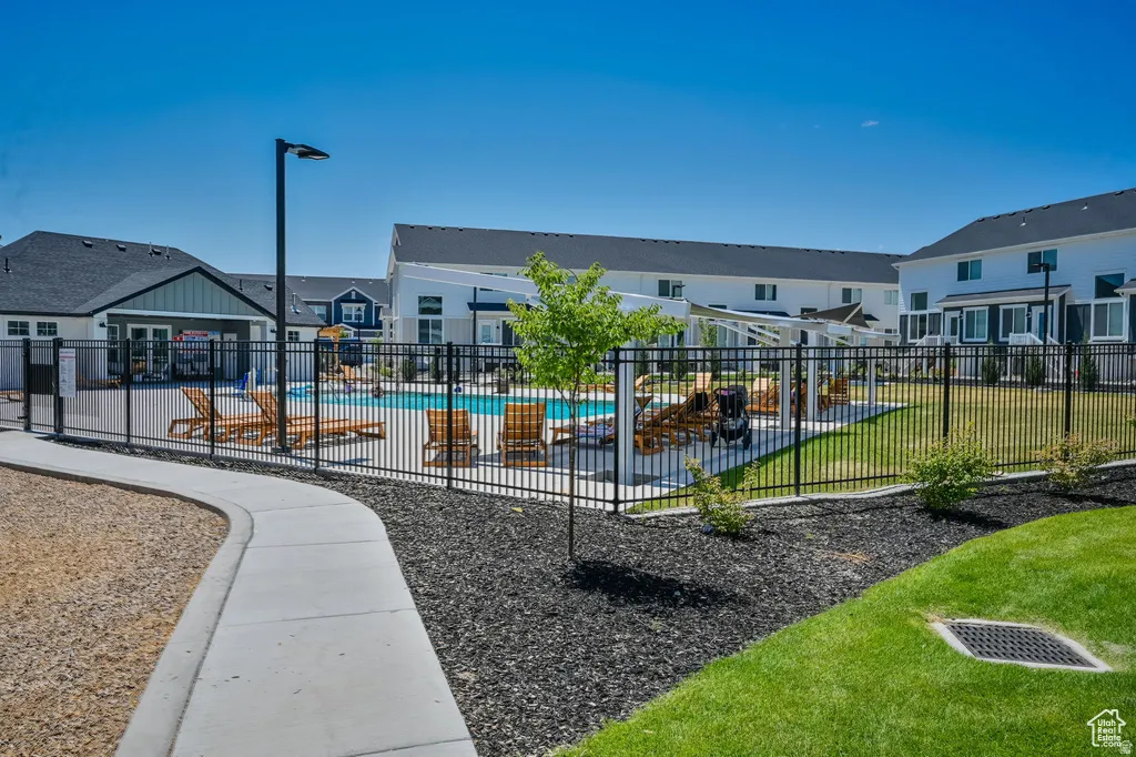 Surrounding community featuring a swimming pool and a residential view