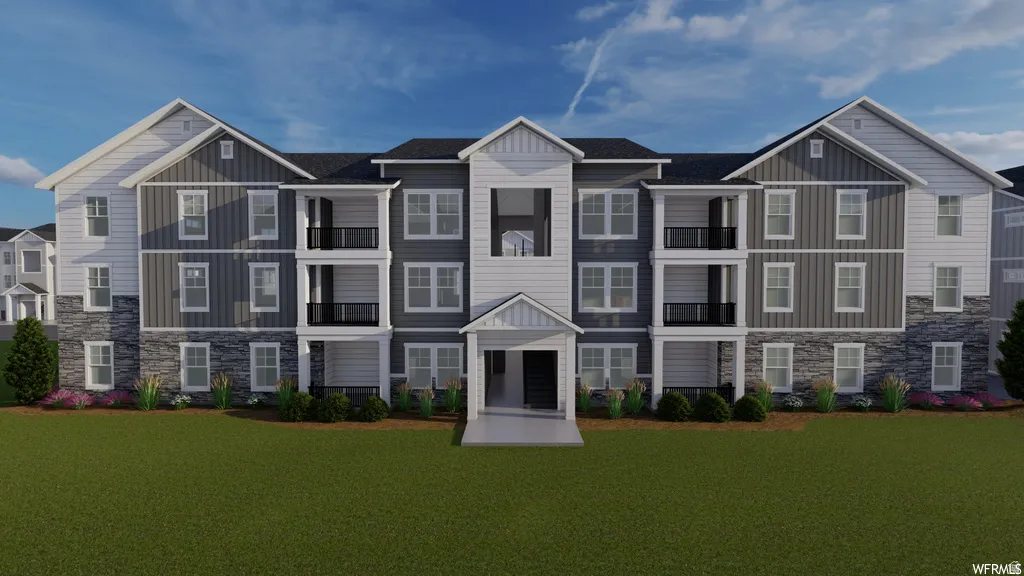 View of front facade featuring stone siding and board and batten siding