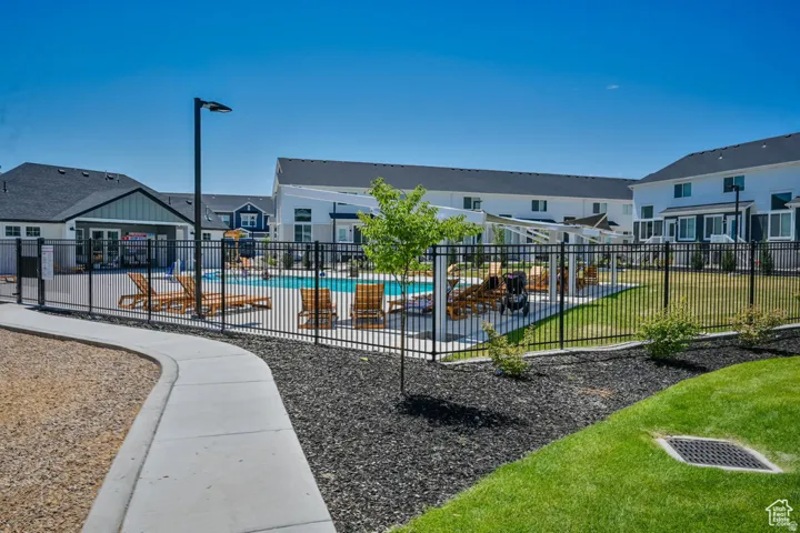Surrounding community featuring a swimming pool and a residential view