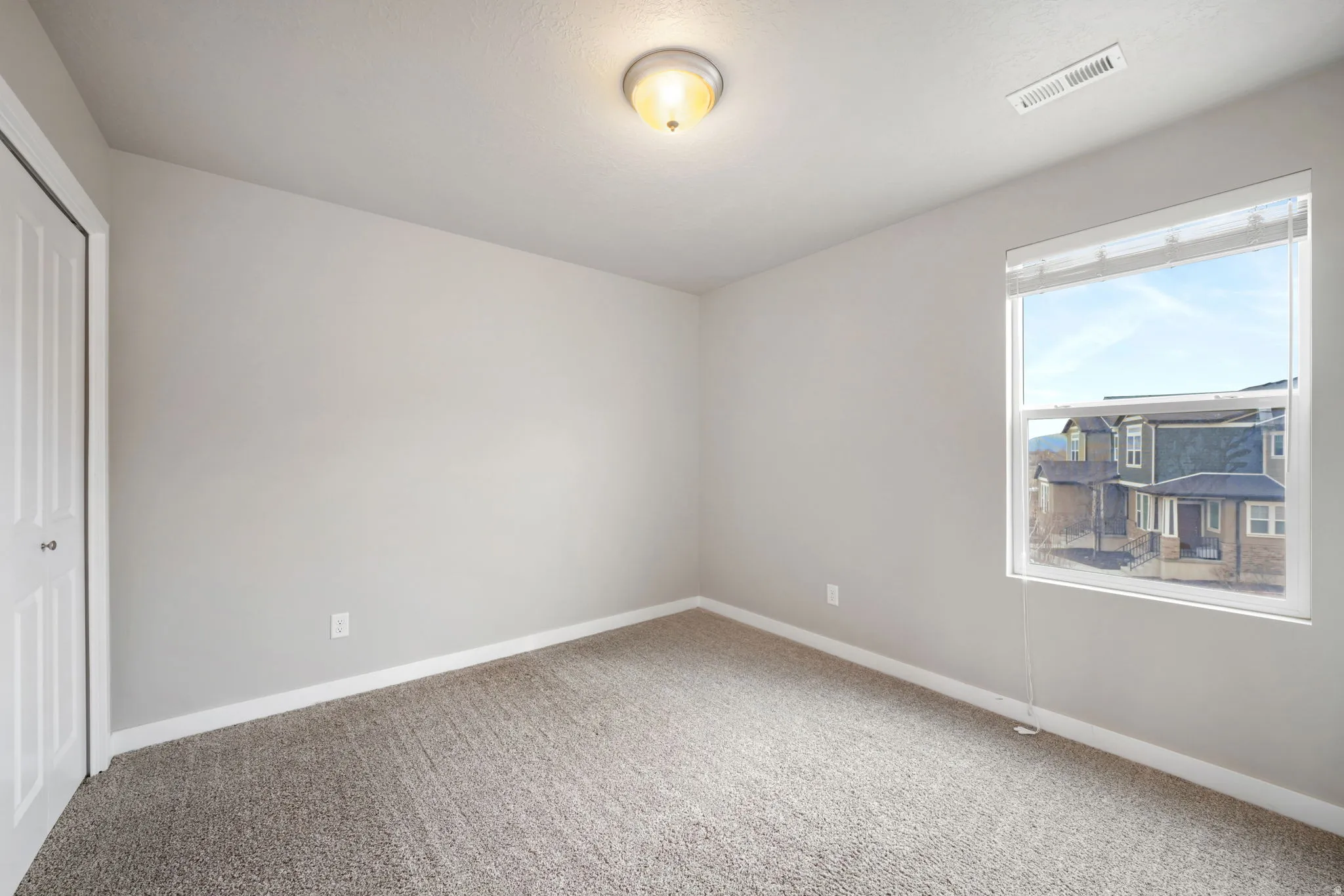 Unfurnished bedroom with a closet and carpet