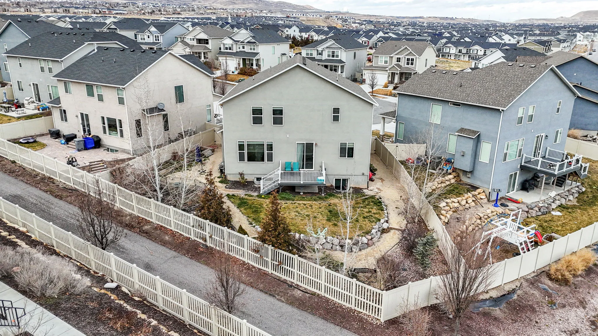 Rear view of property with stucco siding, a fenced backyard, and a mountain view