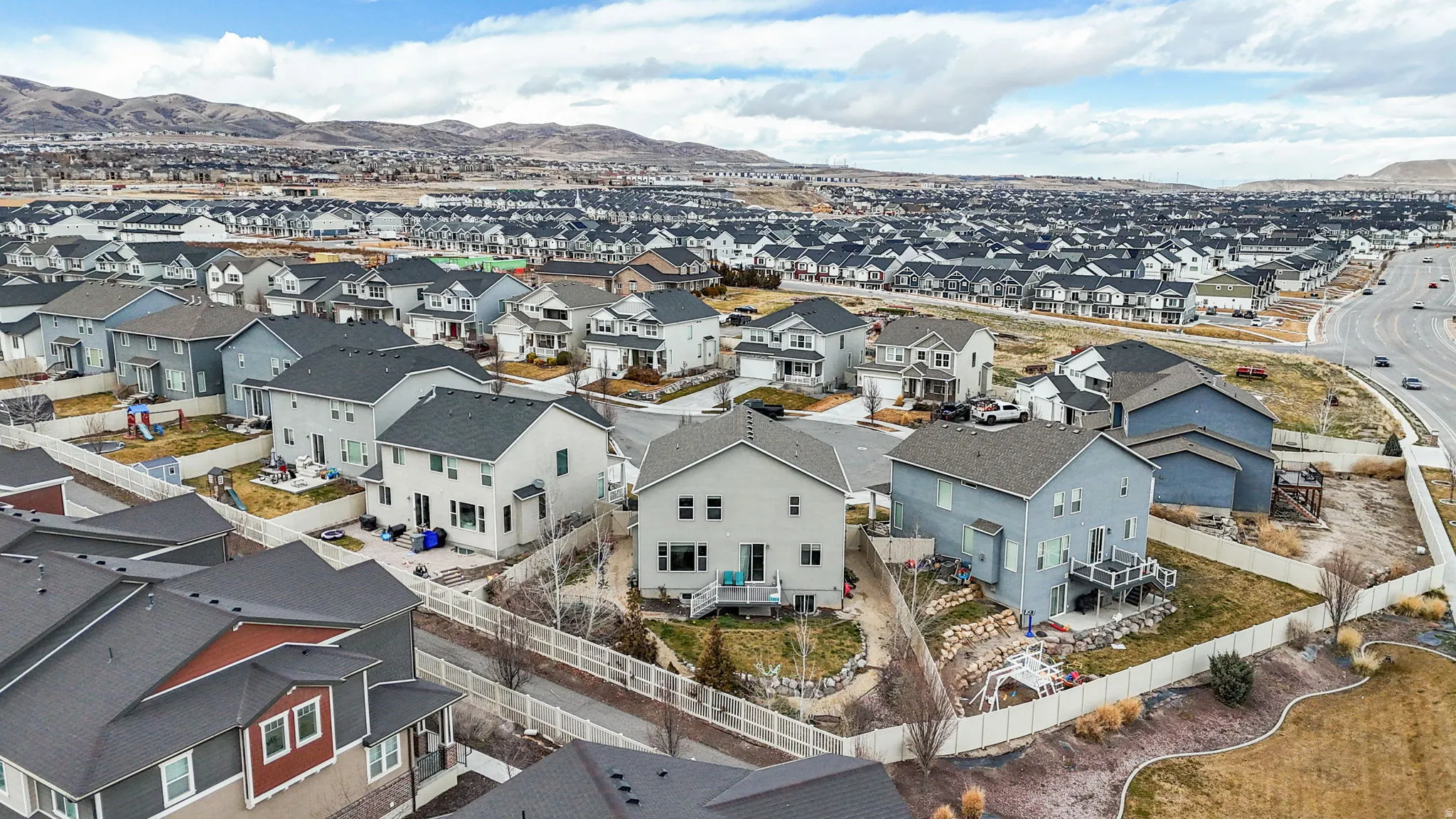 Aerial perspective of suburban area featuring a mountainous background