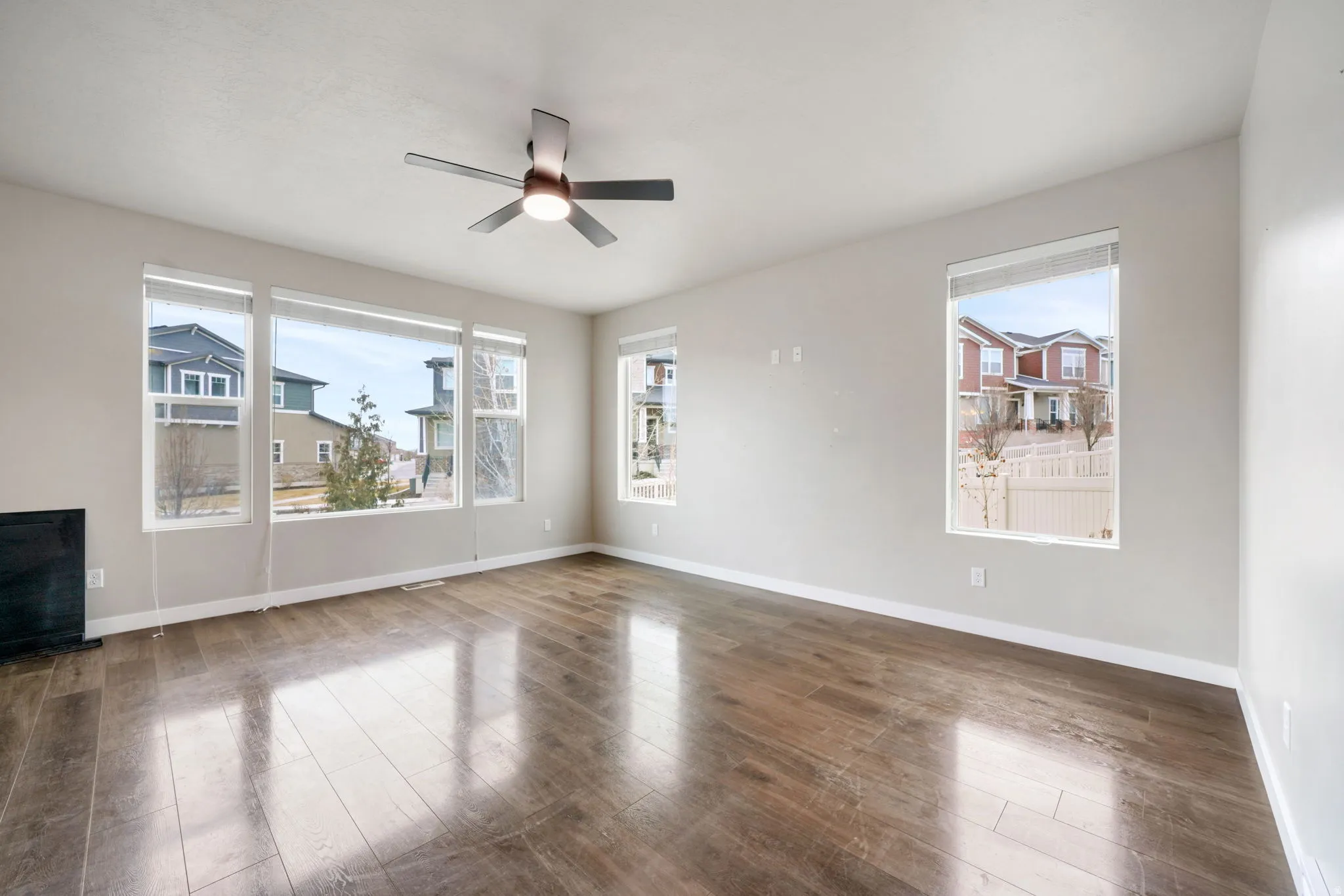 Spare room featuring wood finished floors and ceiling fan