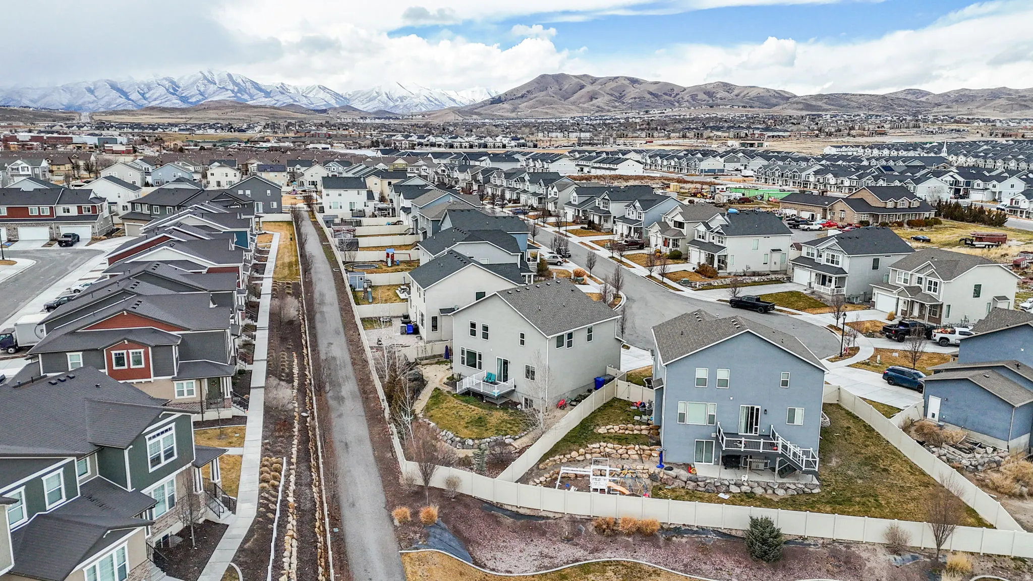 Aerial perspective of suburban area with a mountain backdrop