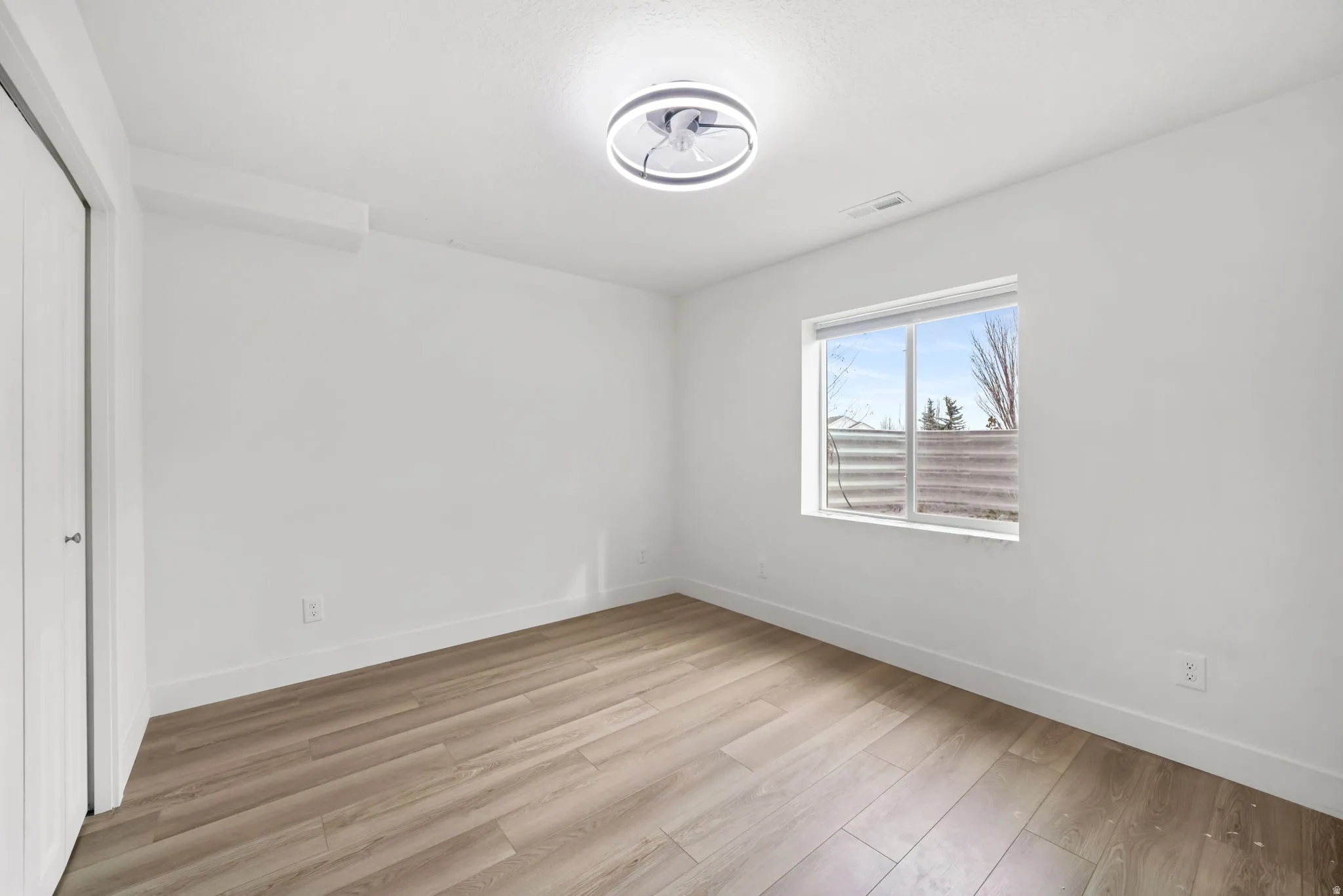 Unfurnished bedroom with a closet and light wood finished floors