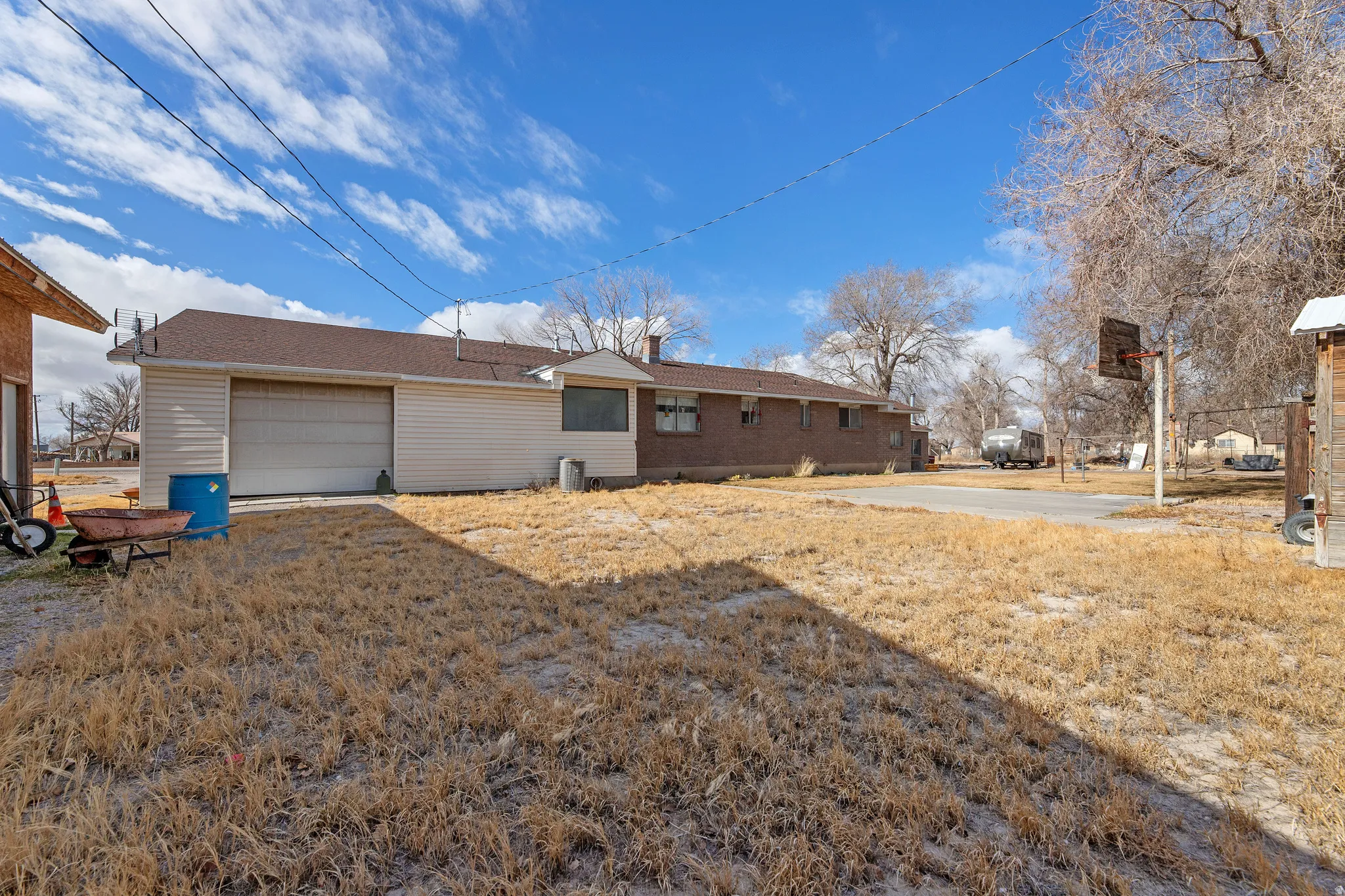 Rear view of house with a garage and a lawn