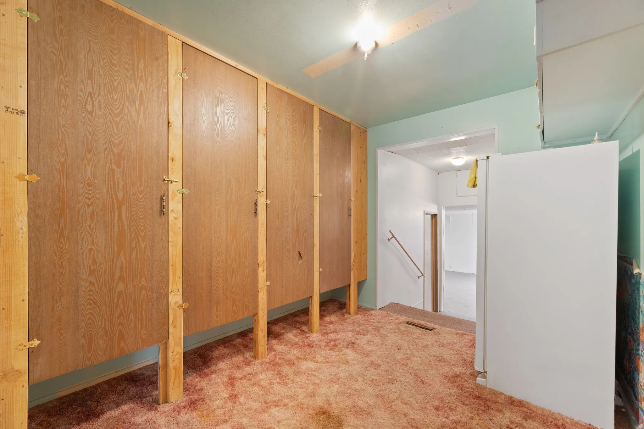 Hallway with an upstairs landing and carpet