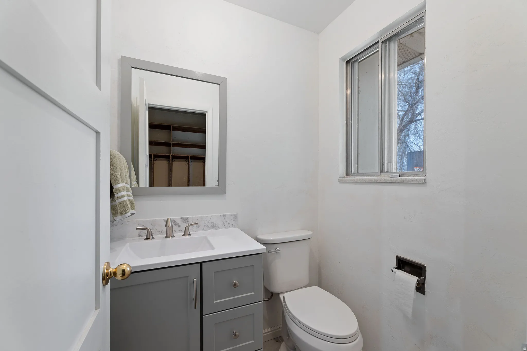 Half bath featuring toilet and vanity