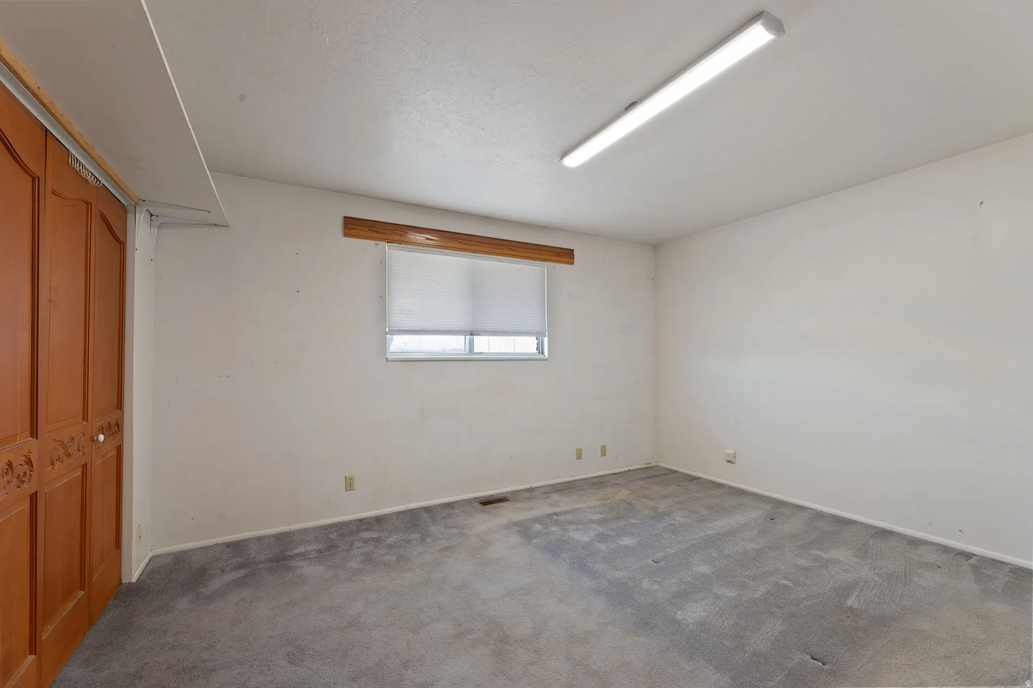 Unfurnished bedroom featuring a closet and carpet flooring