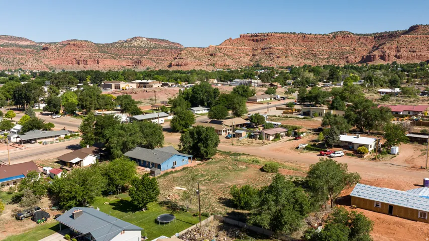 Aerial view of property's location featuring a mountain backdrop and nearby suburban area
