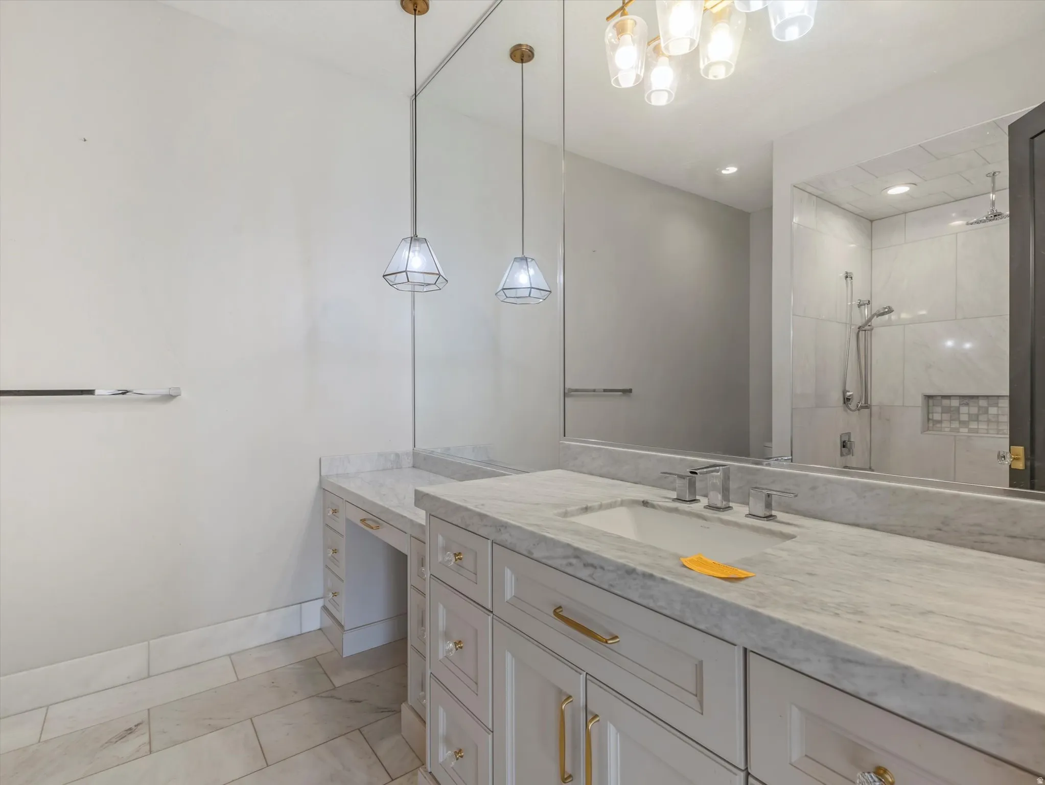 Full bath featuring vanity and tiled shower