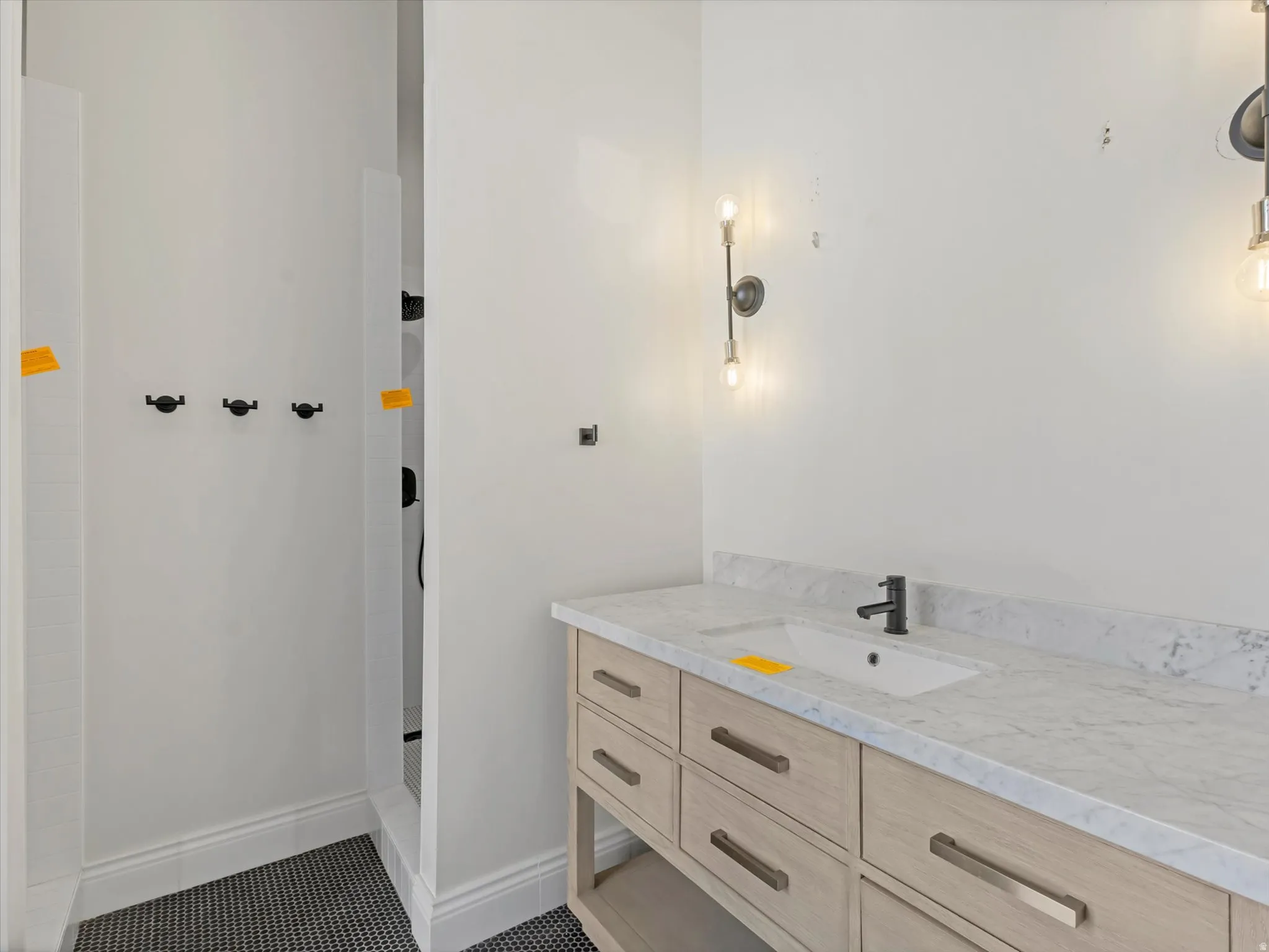 Pool Casita double shower bathroom with vanity, dark tile patterned floors, and a shower