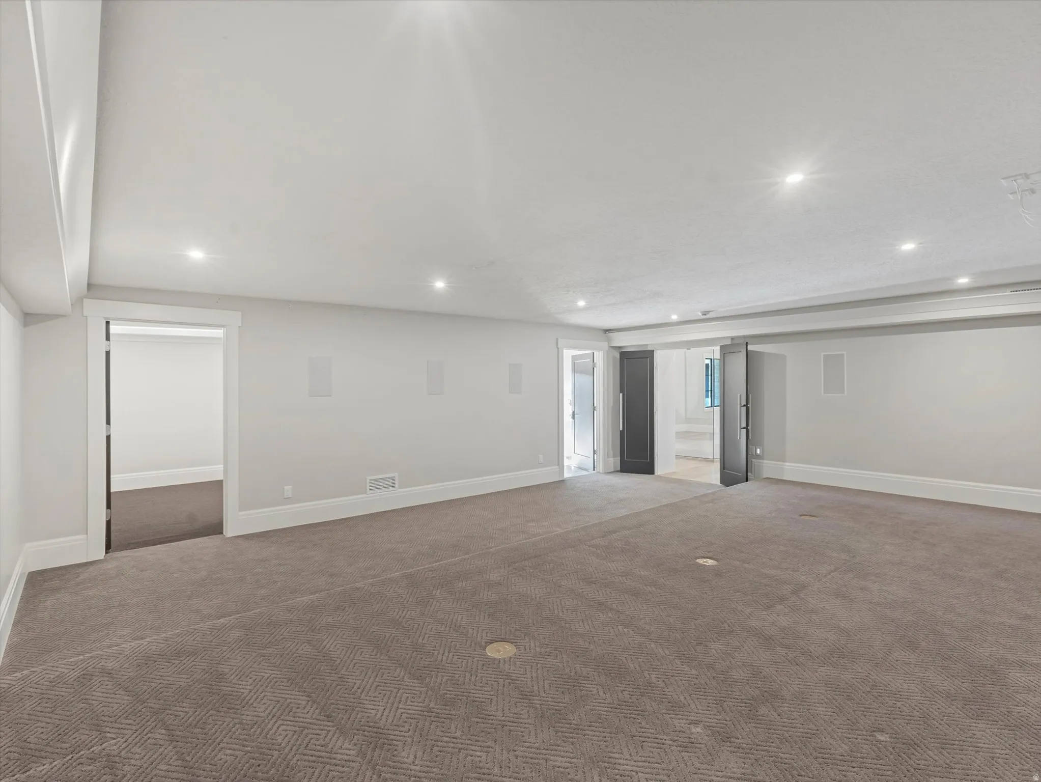 Theatre room featuring carpet floors, recessed lighting, and surround sound