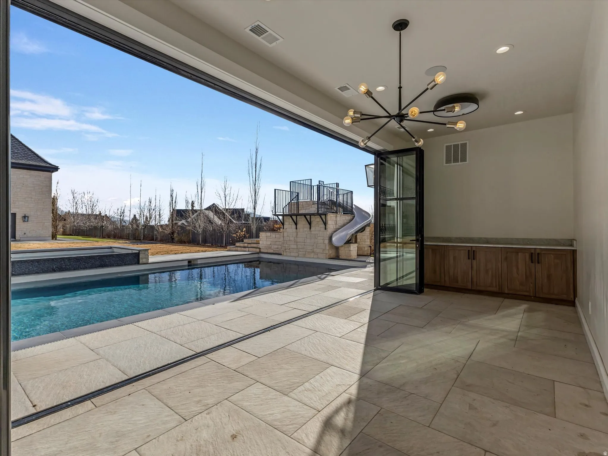 Open air Casita looking out to the swimming pool featuring a water slide and a patio