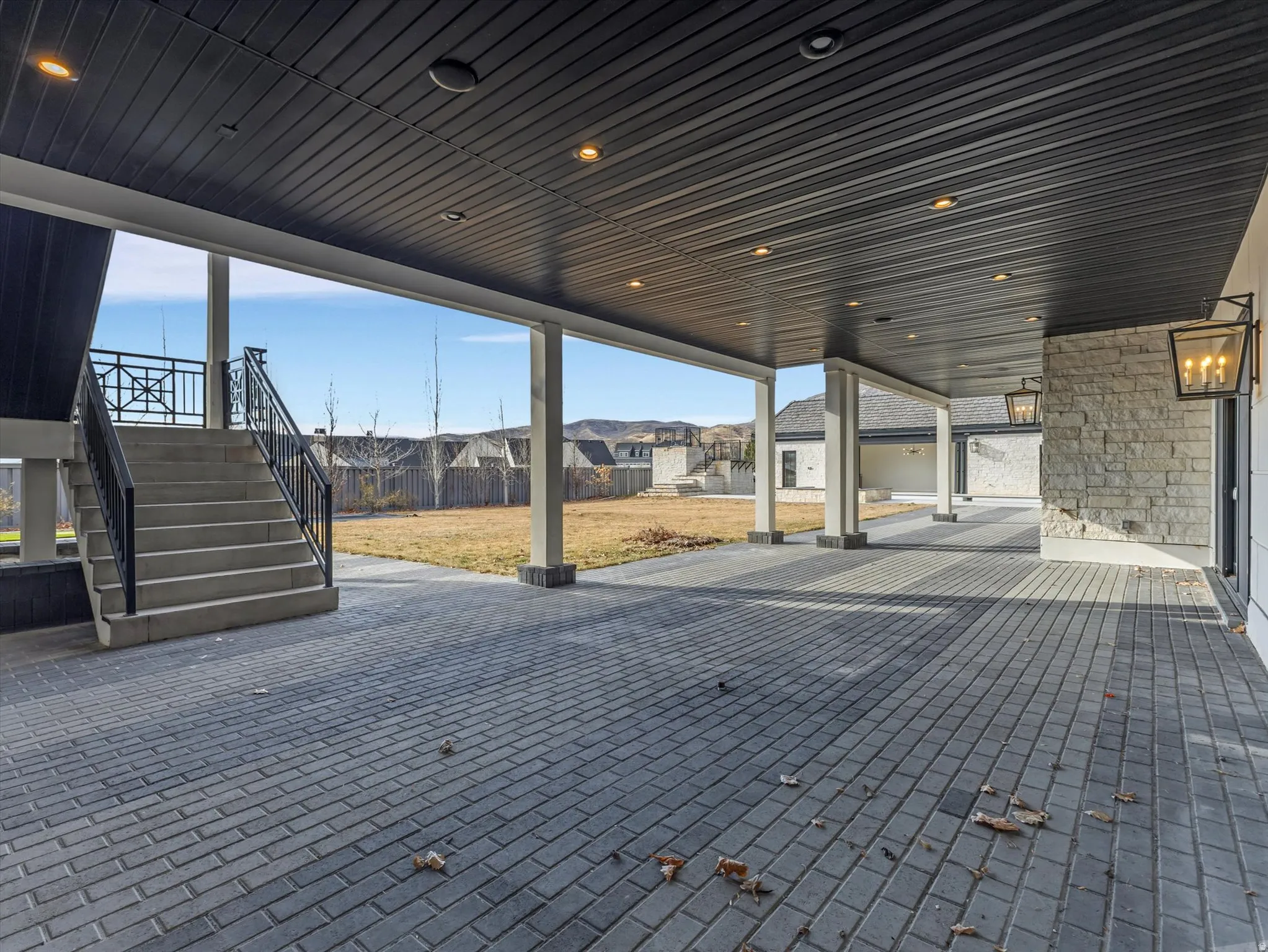 Lower-level walkout from kitchen to patio / terrace featuring a residential view and stairway
