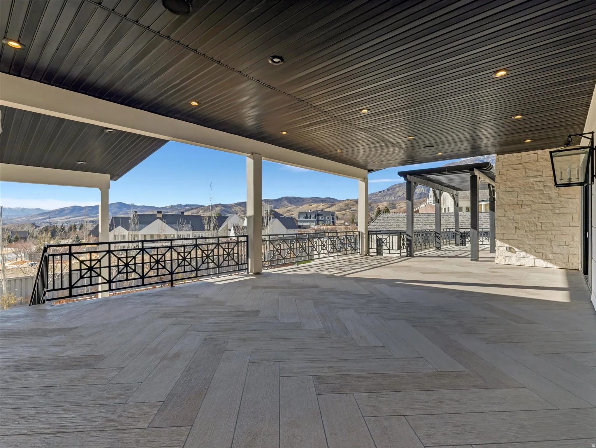 Kitchen walkout wooden deck featuring a mountain view and a patio