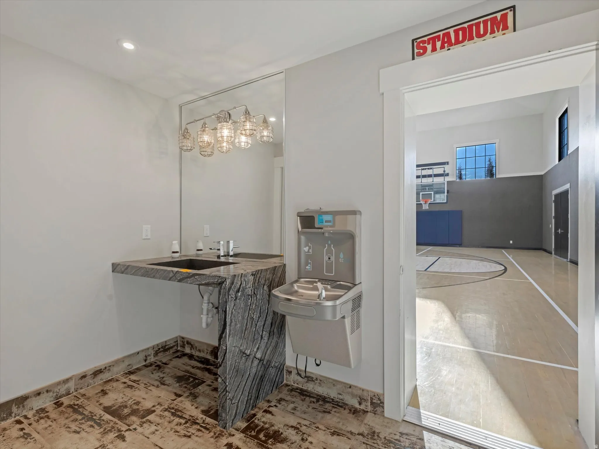 Half bathroom entrance 2 to the basketball court featuring a sink and recessed lighting