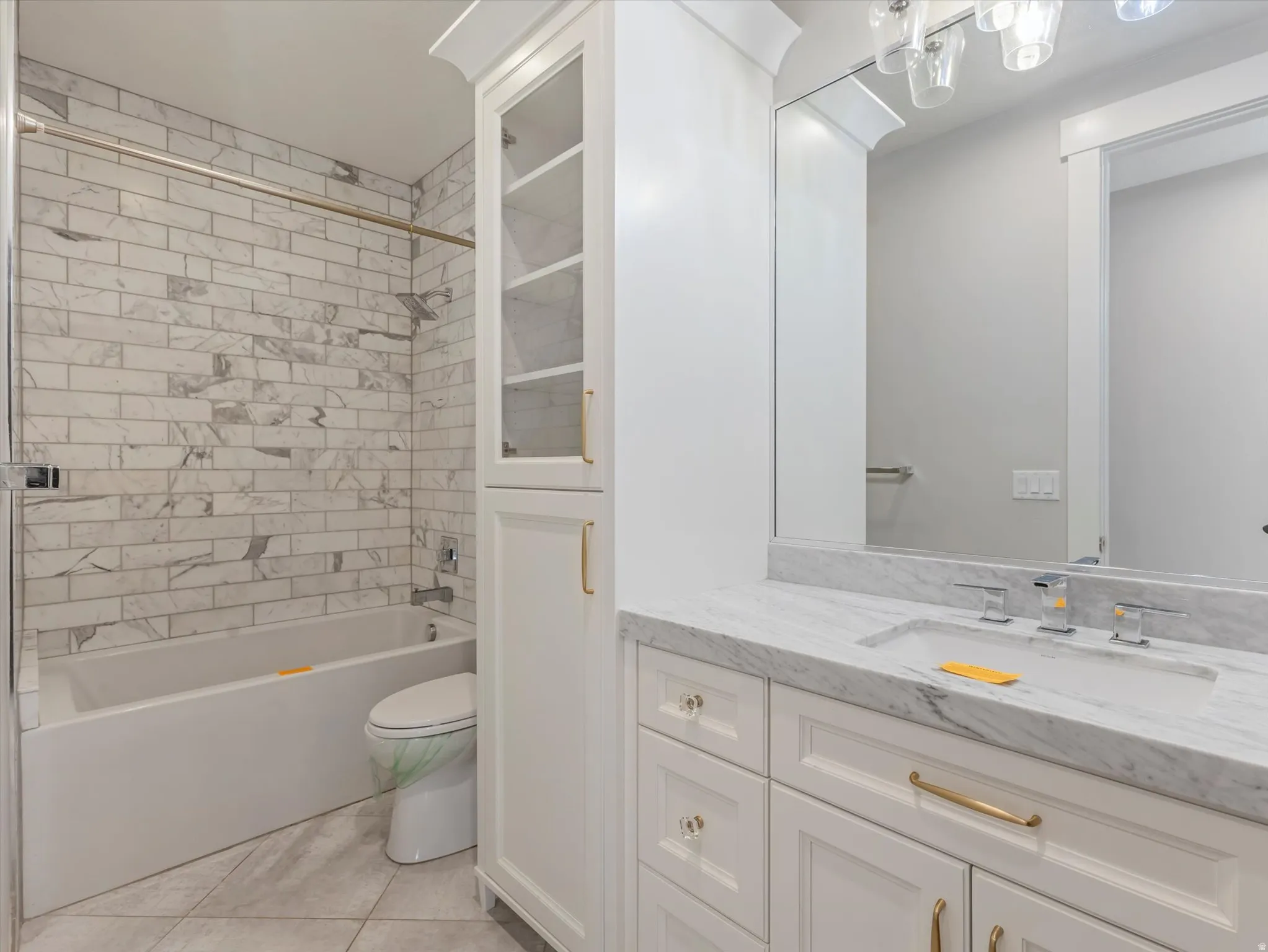 Bathroom featuring  shower combination, vanity, and light tile patterned floors